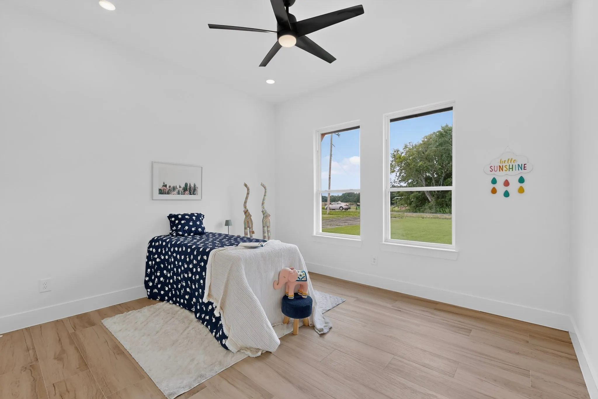 Room featuring wood-finish flooring, recessed lighting, and a contemporary ceiling fan