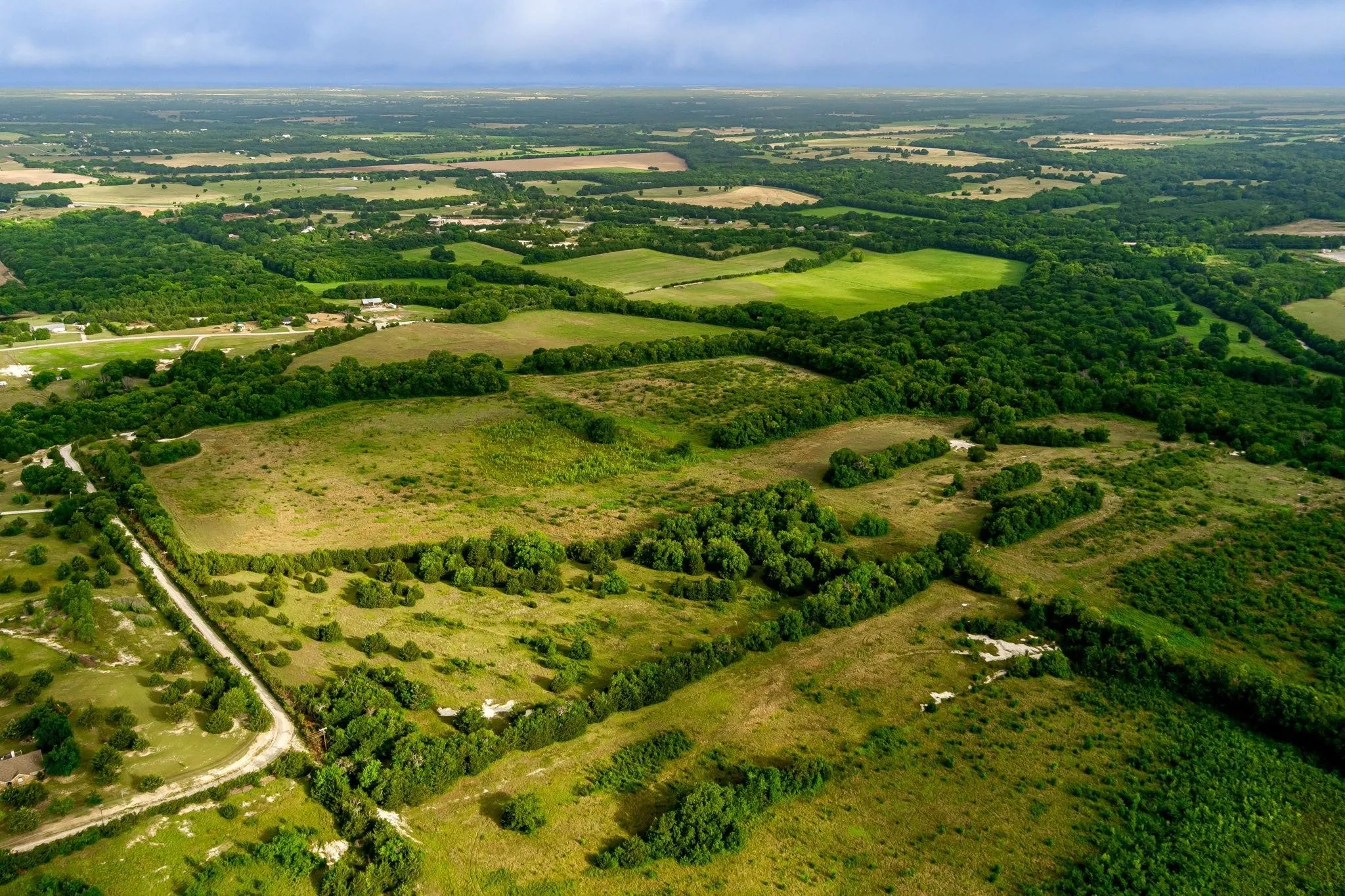 Expansive rural landscape featuring extensive green acreage