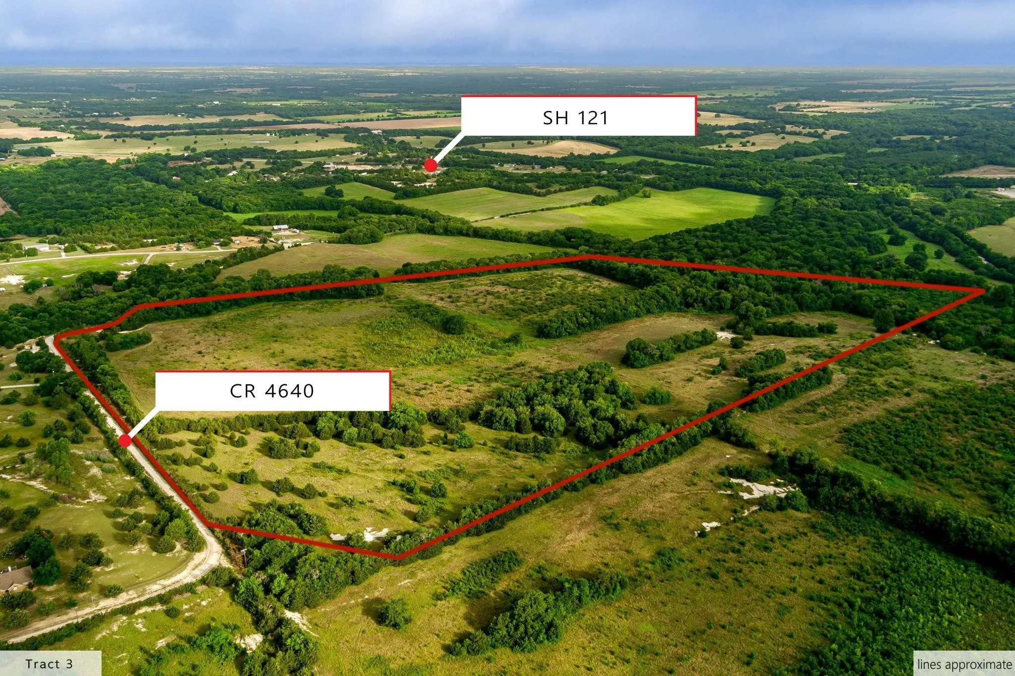 Expansive acreage featuring a mix of open fields and mature tree lines