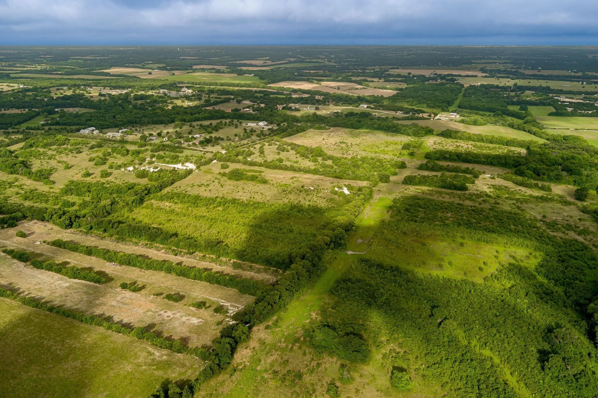 Expansive rural landscape featuring extensive green foliage and open fields