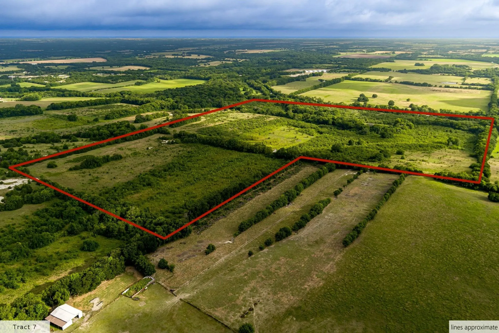Expansive rural land featuring varied terrain and abundant tree cover