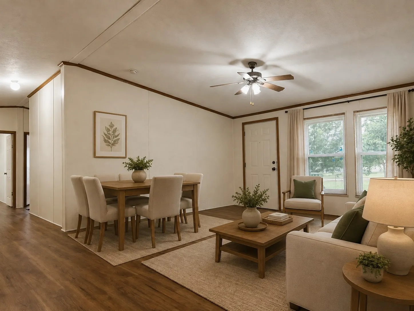 Wood-finish flooring, ceiling fan with light fixture, multiple windows, interior door, and a hallway