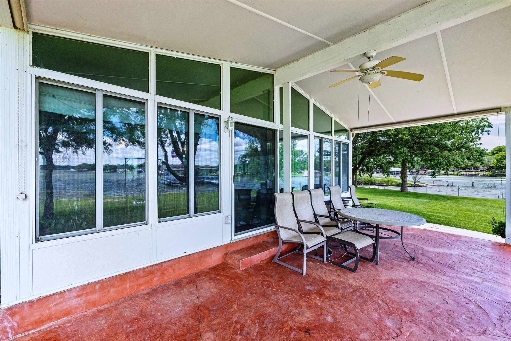 Stained concrete covered patio with pull down shades makes for year round comfort!
