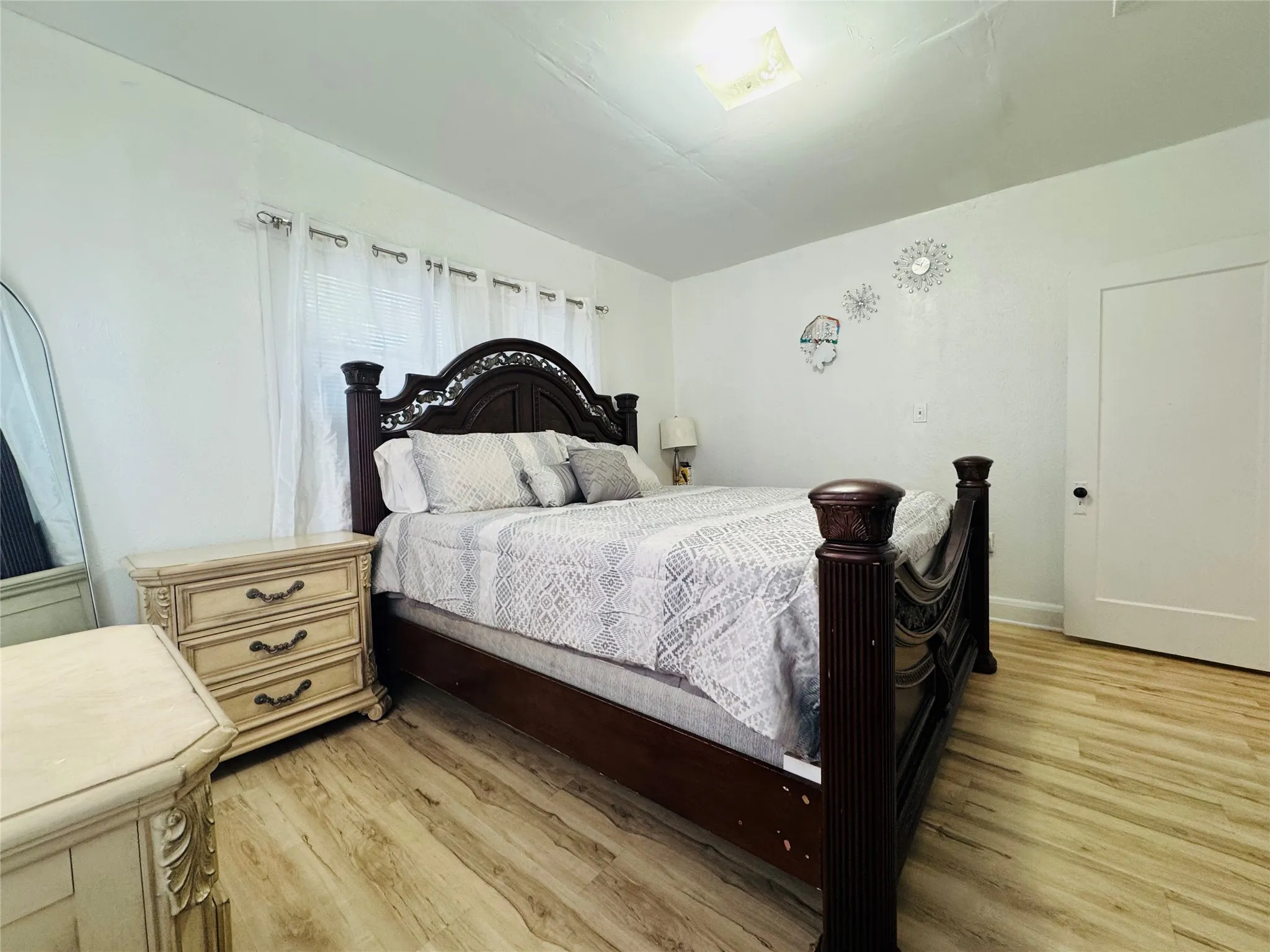 Light wood-finish flooring complements white walls