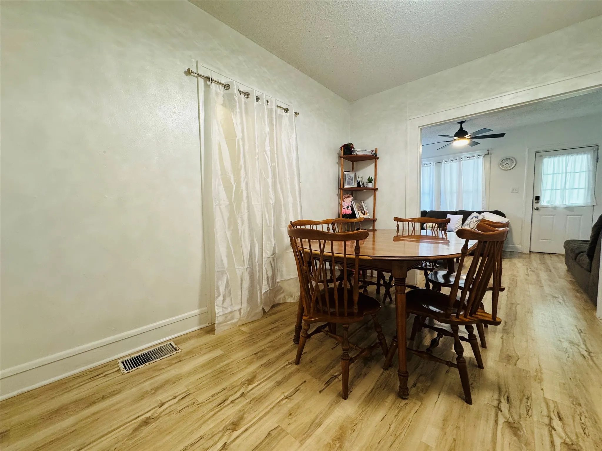 Dining area featuring wood-finish flooring and light-toned walls