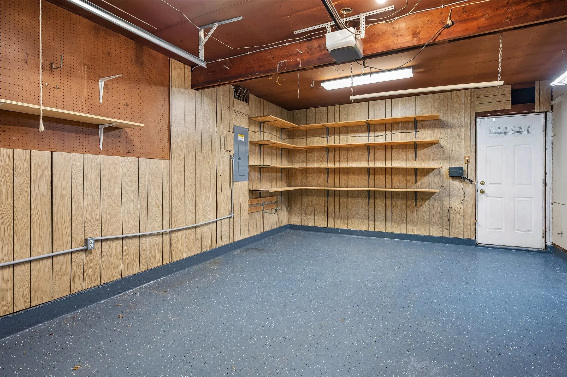 Nice finished out garage with epoxy covered floor, Garage door opener, newer electric panel and sprinkler system controller with remote control.