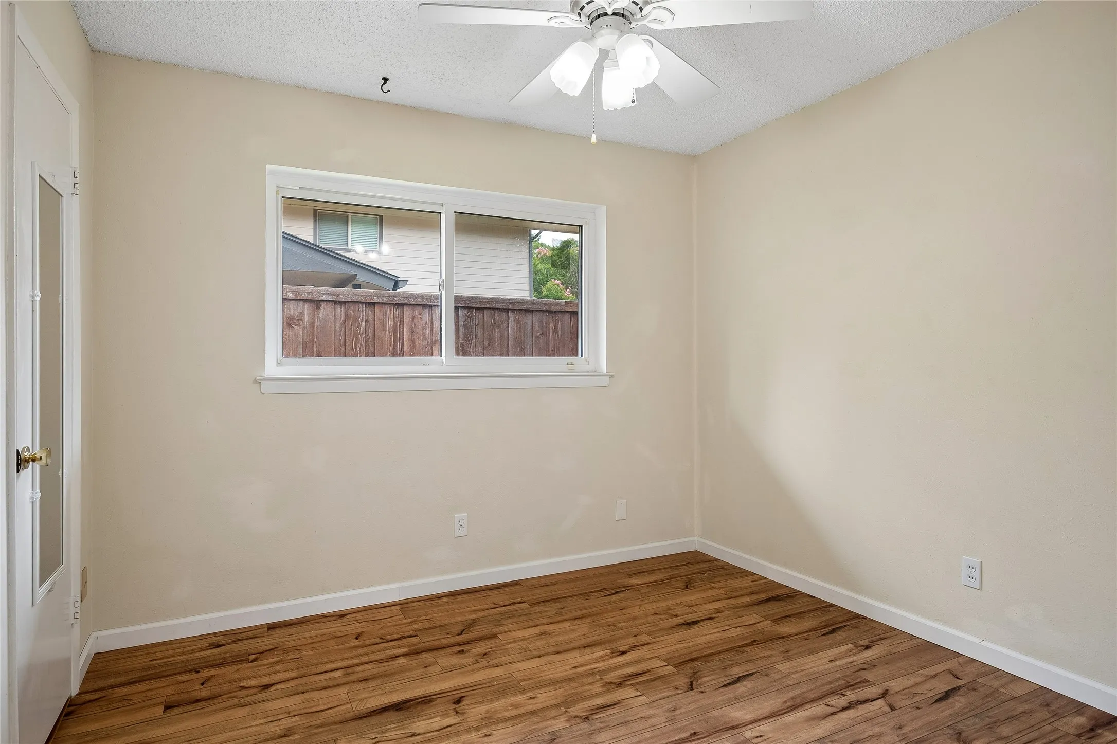 Third bedroom with ceiling fan and walk-in closet.