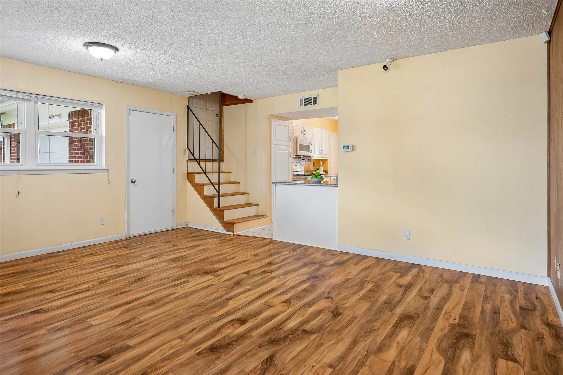 Extra sitting area to left and dining area to right open to kitchen.