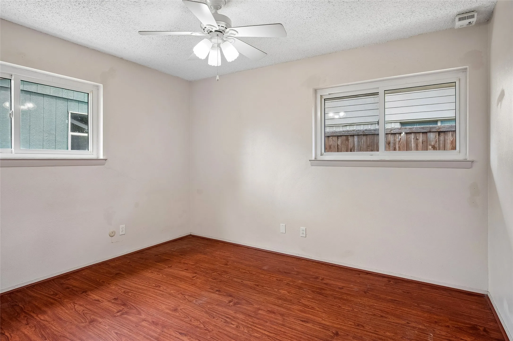 Primary bedroom with ceiling fan, walk-in closet and ensuite bath.