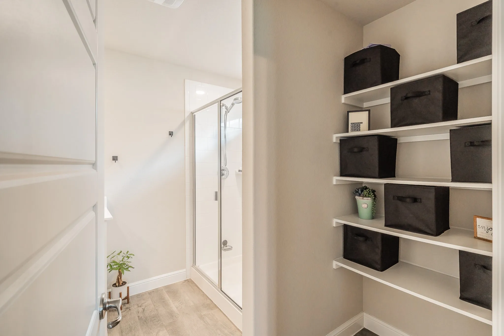 Bathroom with a glass-enclosed shower and a built-in shelving for storage or display
