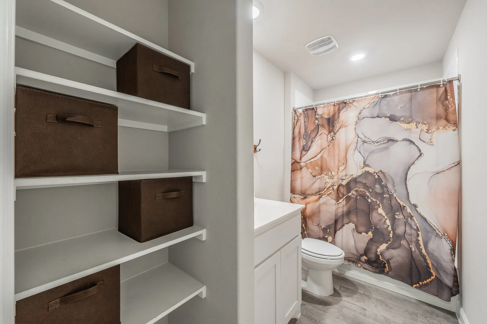 Full bathroom featuring storage or display area. Shower tub combo