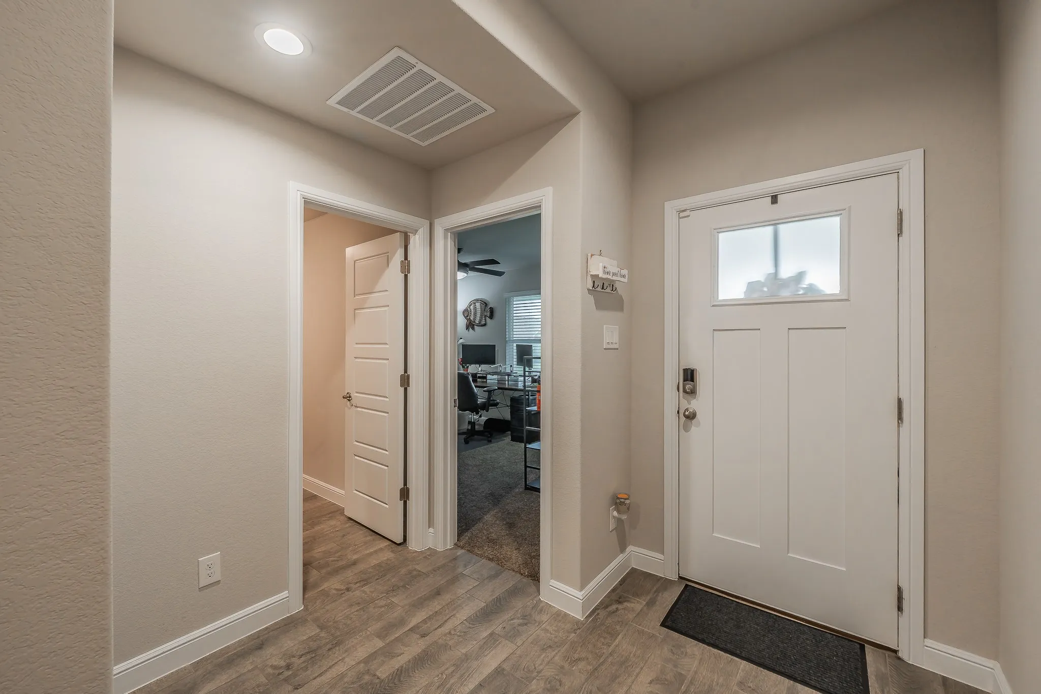 Entryway featuring ceramic plank tile and recess lighting