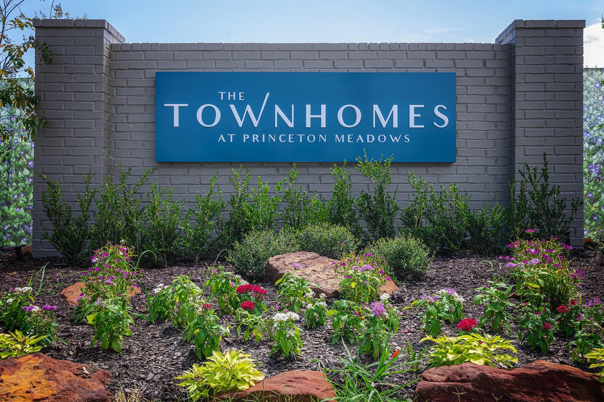 Brick masonry entry sign with a blue panel