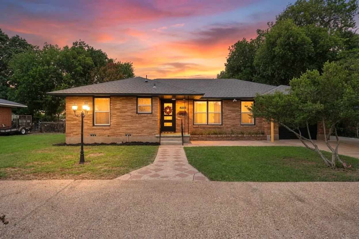 Single-story residence featuring a brick exterior with a dark shingle roof