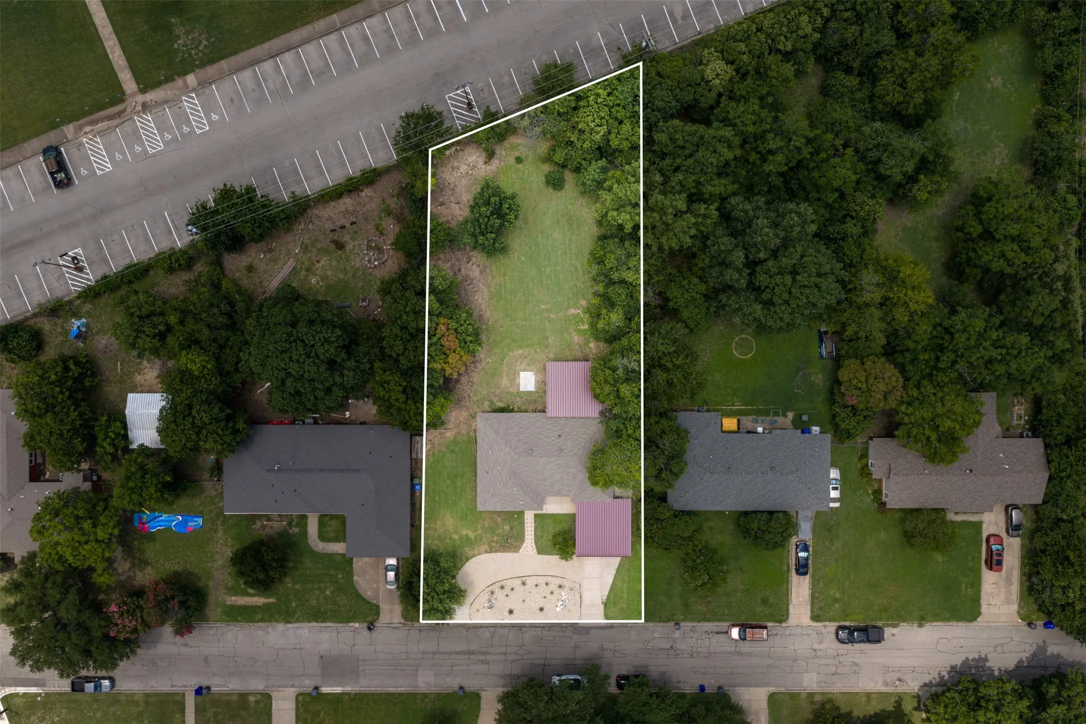 Expansive lot with mature trees and a substantial grassy area