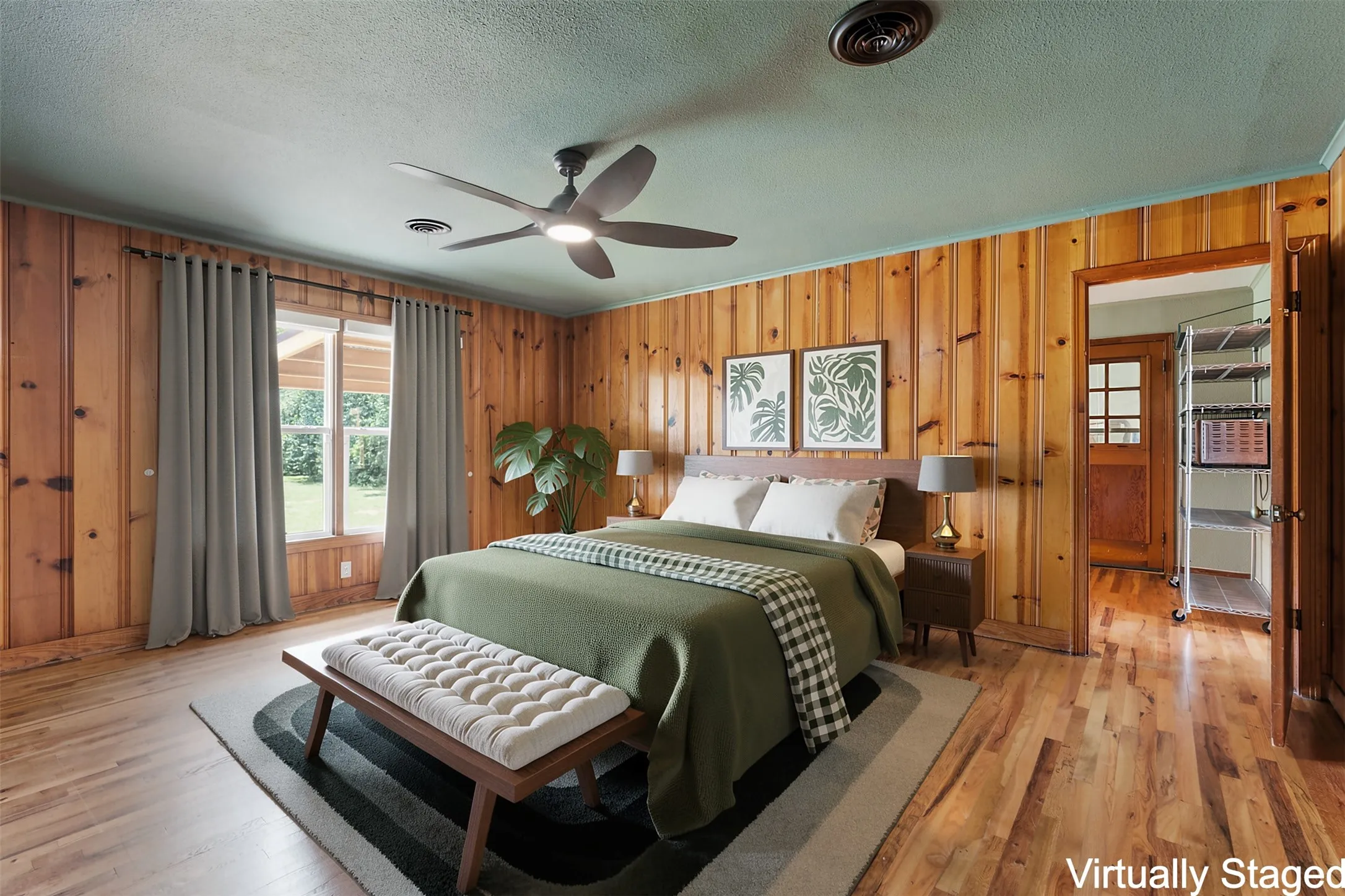 Interior room featuring wood-finish flooring, paneled walls, and a ceiling fan with integrated lighting