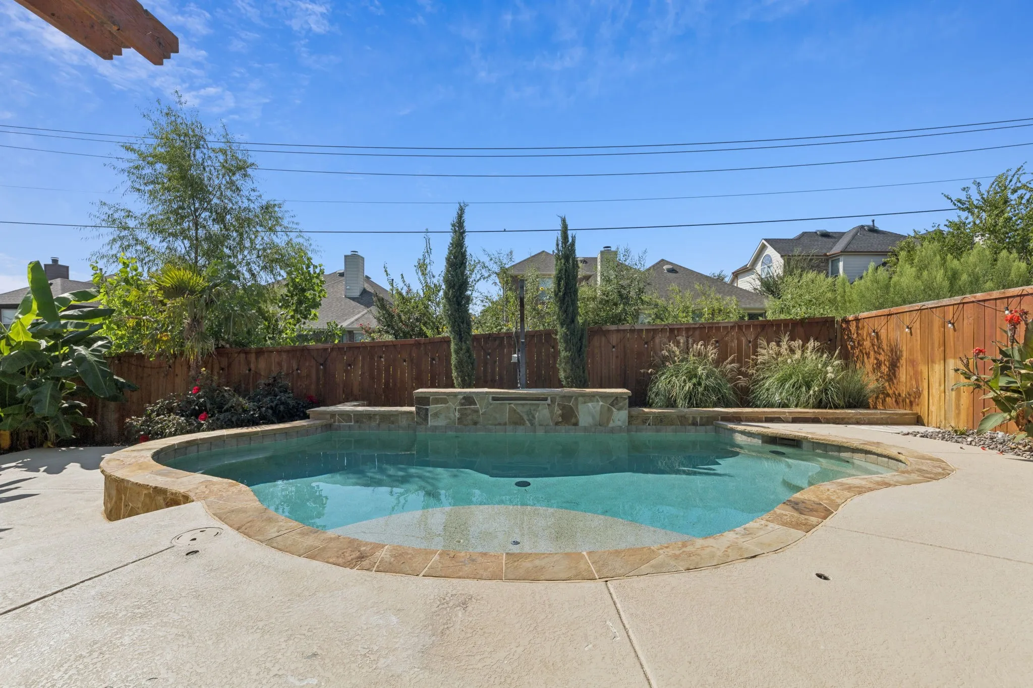 View of swimming pool with a fenced backyard, a patio, and a jacuzzi