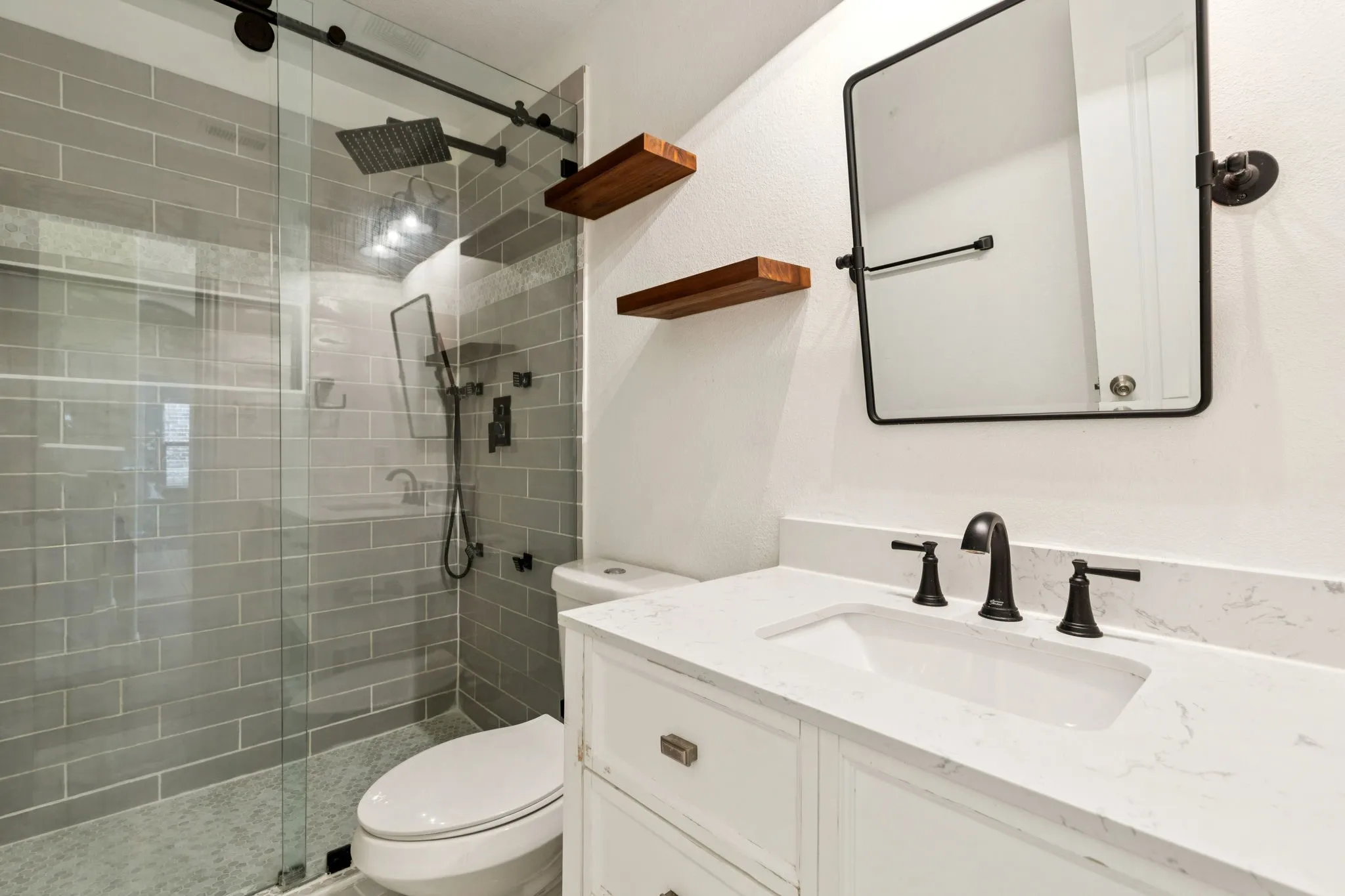 Bathroom featuring vanity and a shower stall
