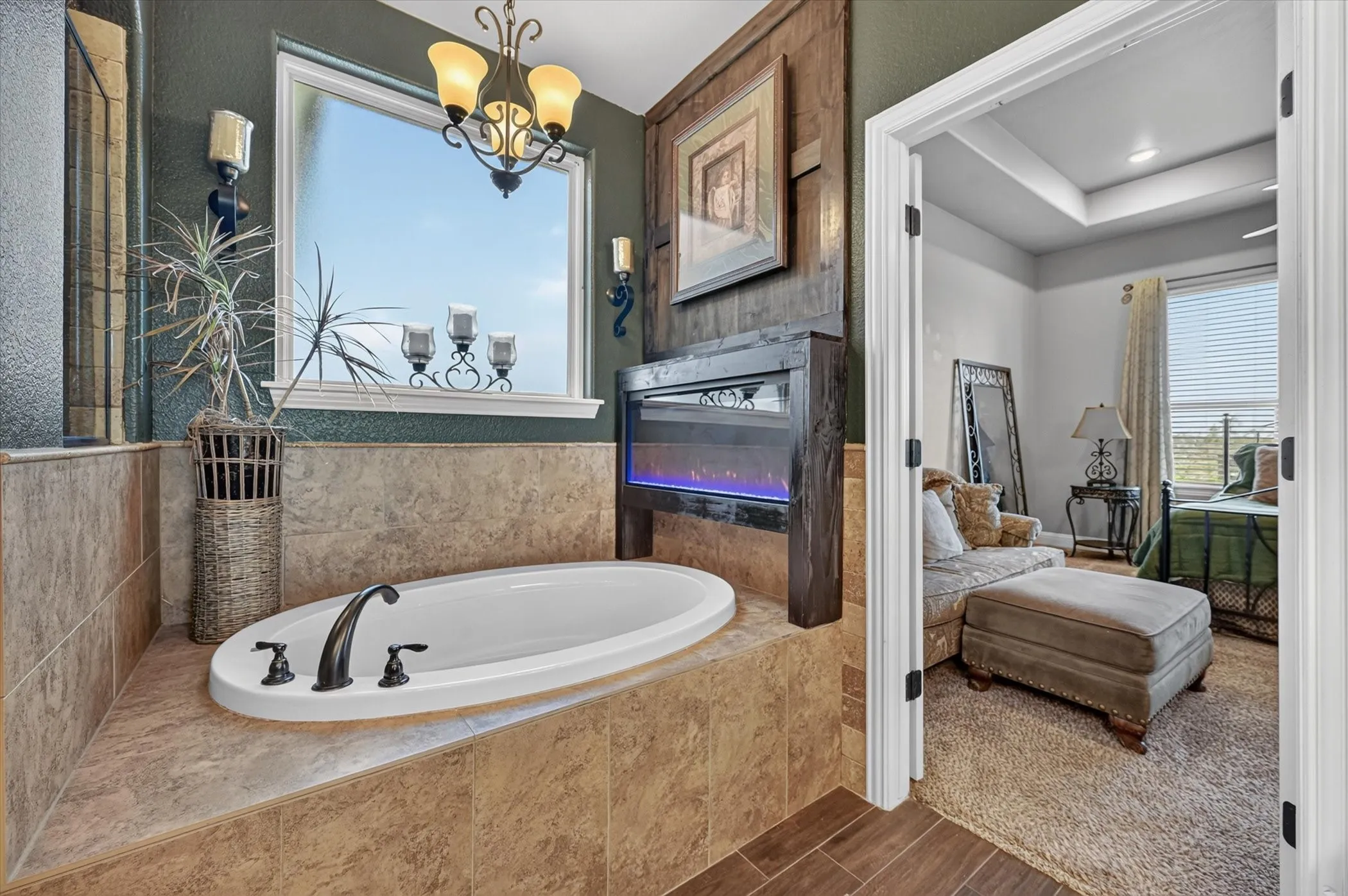 Soaking tub featuring oil-rubbed bronze fixtures, set within a tiled surround