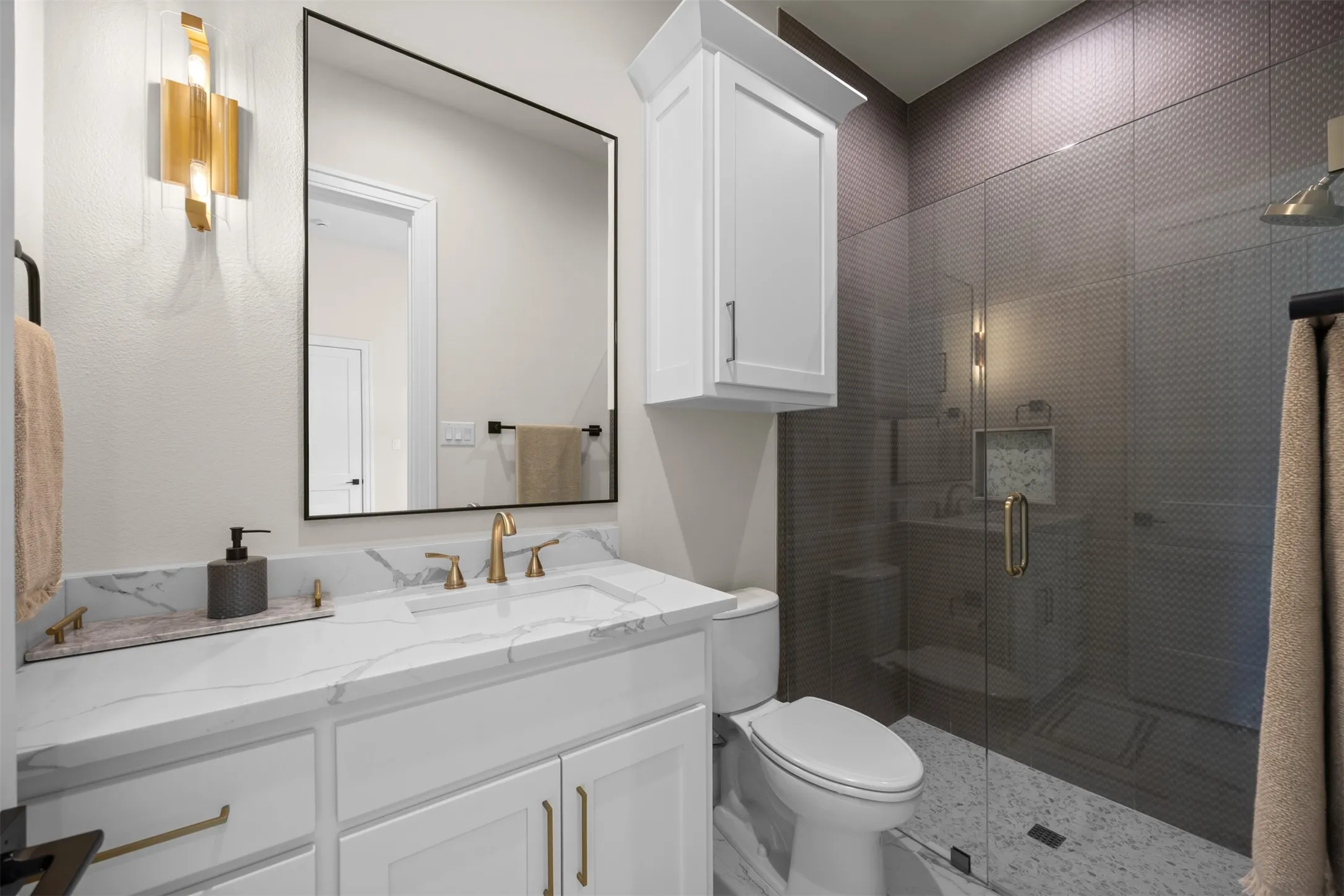 Ensuite bathroom with high style and finish out off one of three secondary bedrooms.The tile selections are perfection!