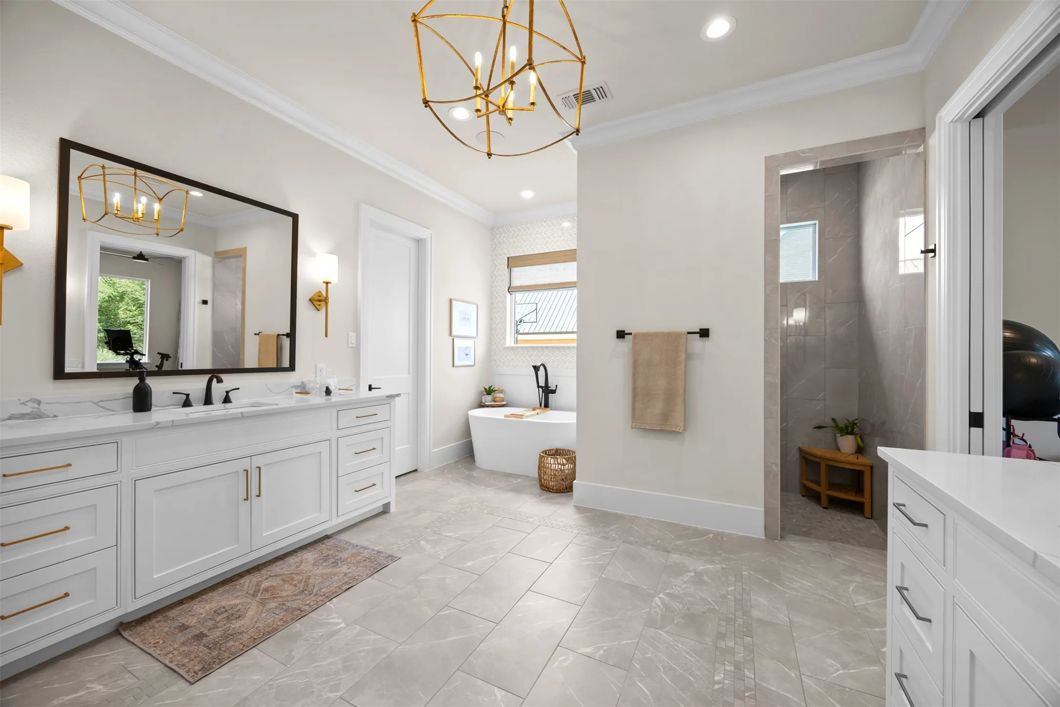 This spa inspired ensuite complete with dual vanities, custom lighting, high end designer tile & hardware, freestanding tub & a Baja style shower. Wow!