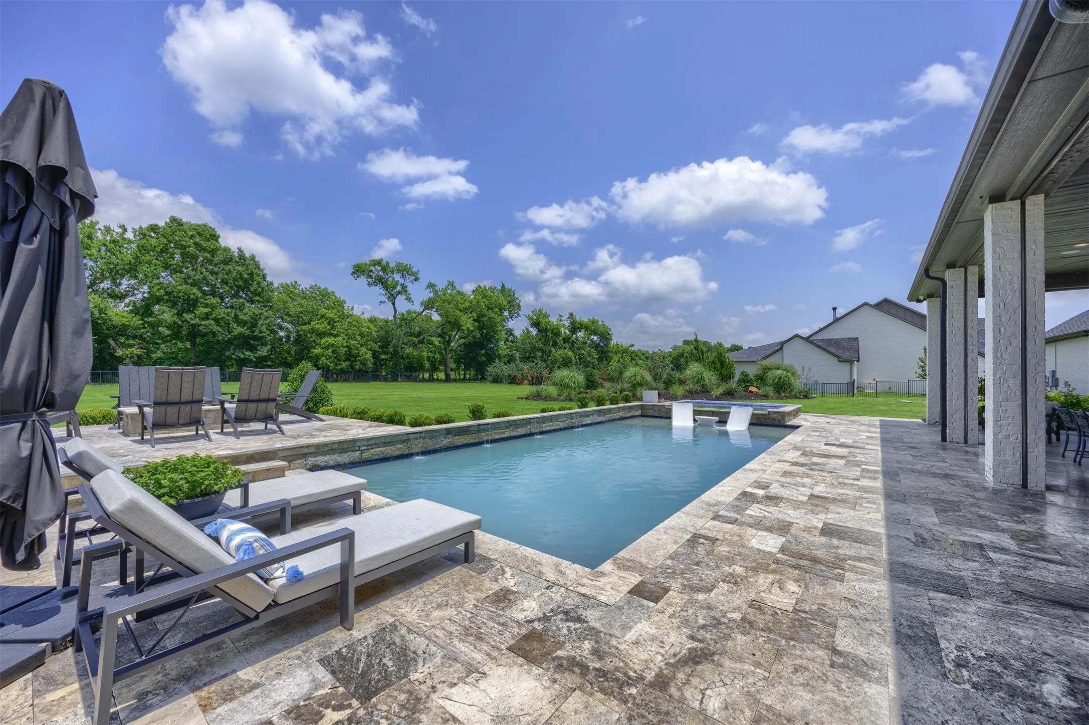 Surrounded by a lush canopy of mature trees, this private oasis features a sparkling pool and spa to cool off in the Texas heat along with a high end tile