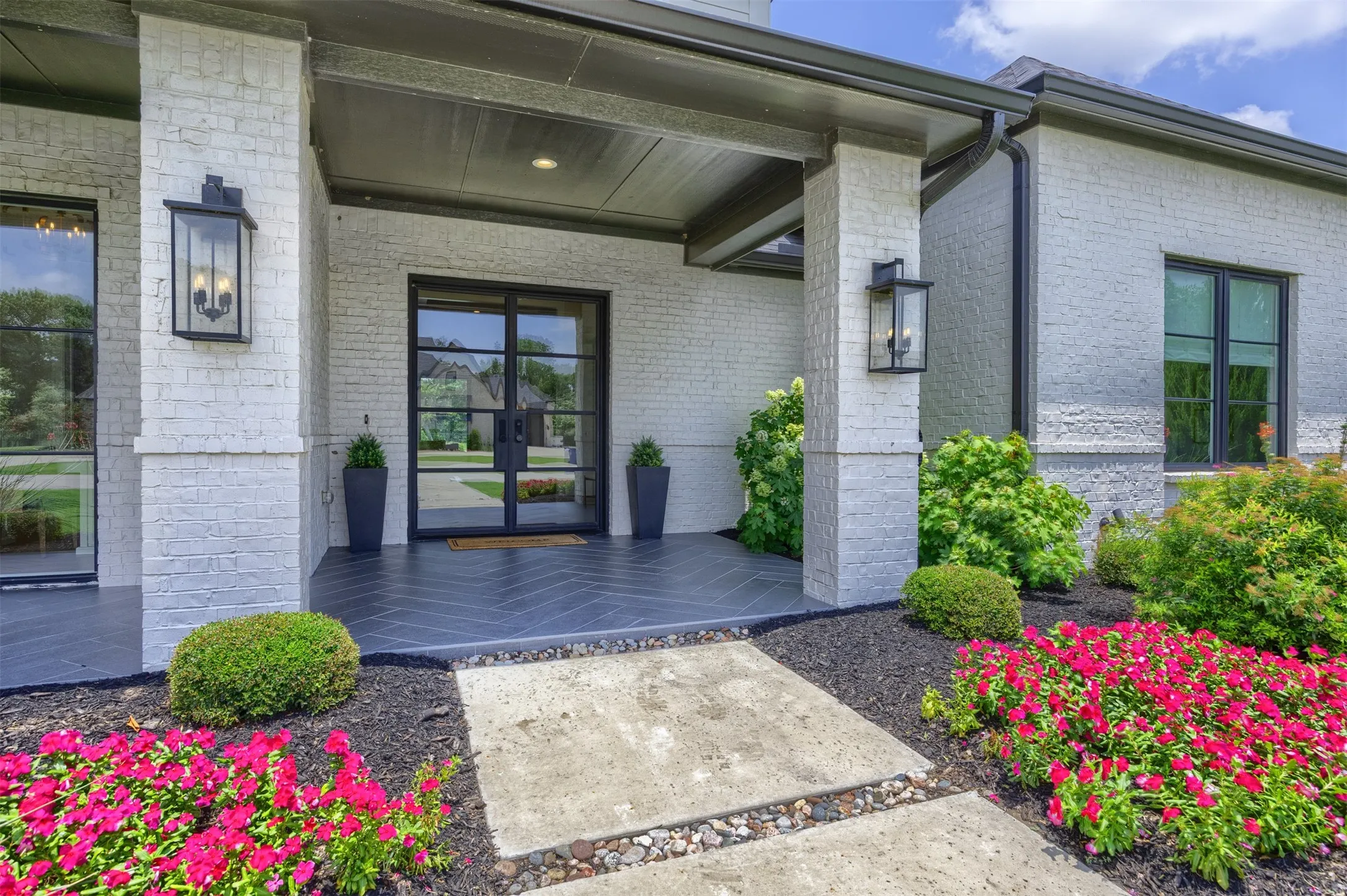 Thoughtfully designed with uncompromising quality & superior attention to detail, this exceptional home offers a refined yet relaxed aesthetic. Stunning double doors and herringbone slate tile greet you as you walk up.