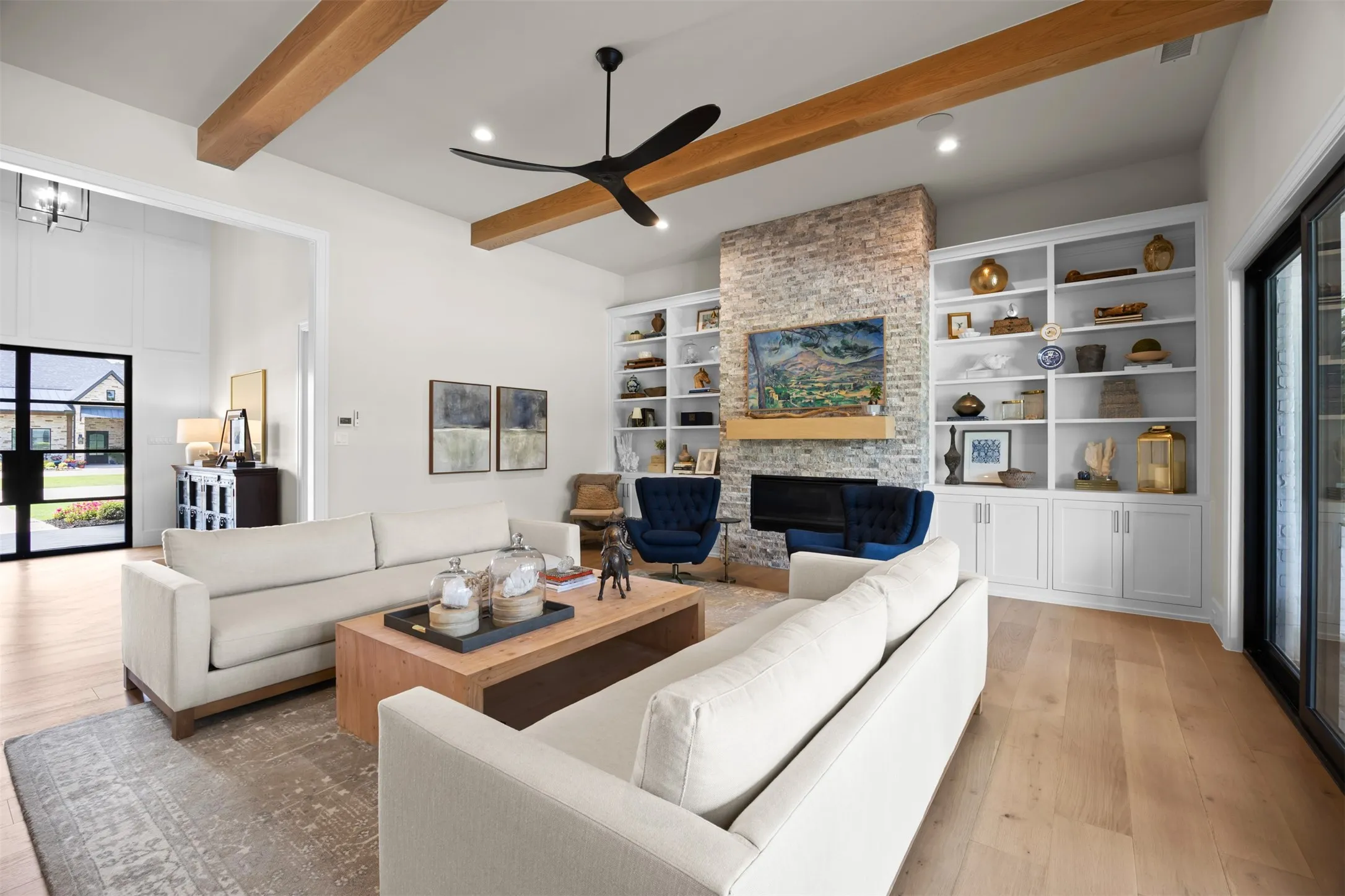 The texture of the tile on the fireplace pair perfectly with the wood beams and floors in this gorgeous space.