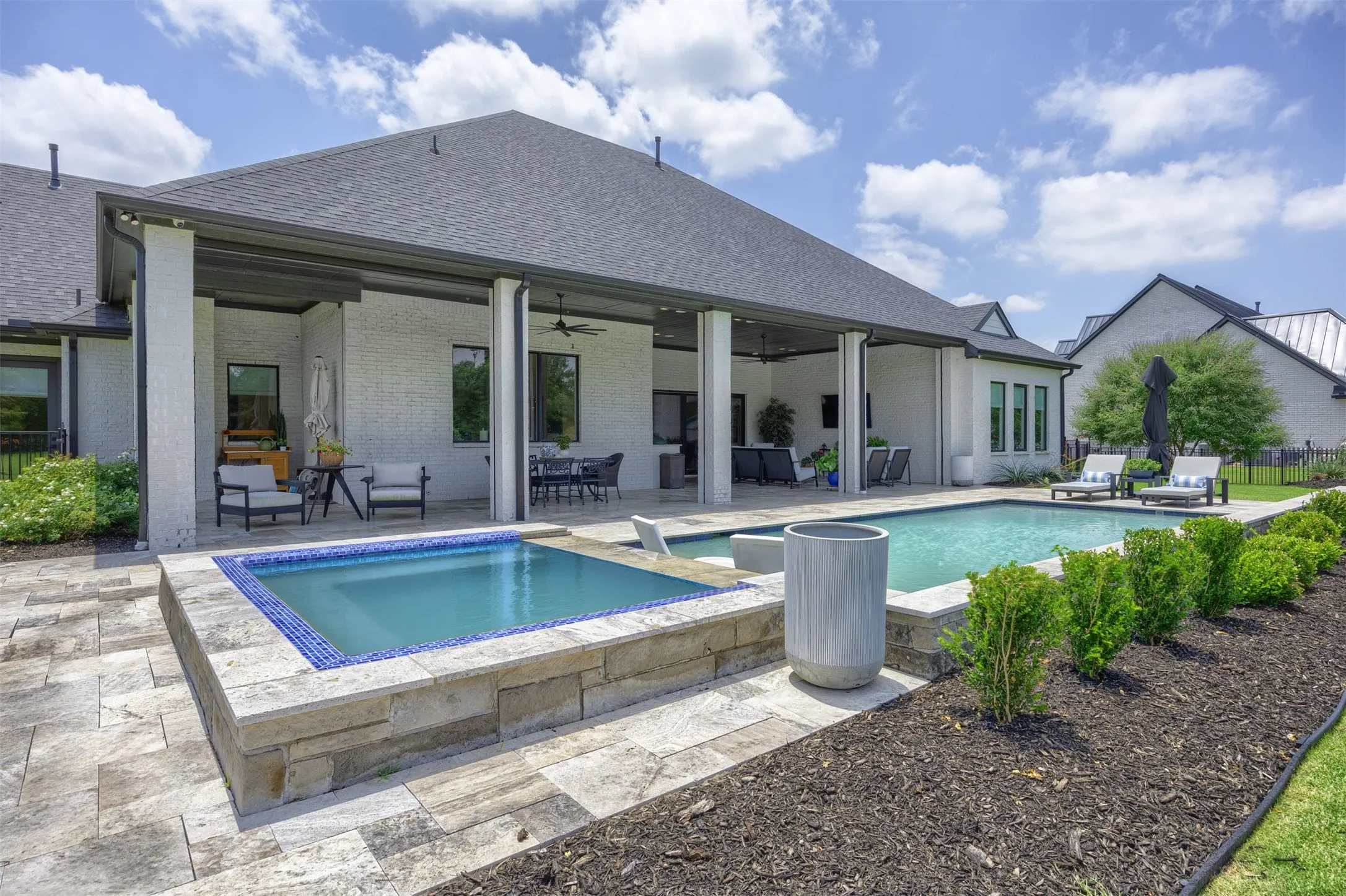Designed for both relaxation and entertaining with several seating areas & motorized screens to create an indoor outdoor set up