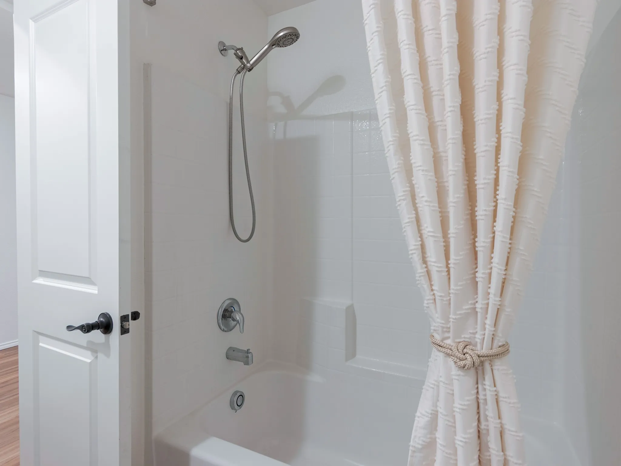 Bathtub with hand held sprayer.