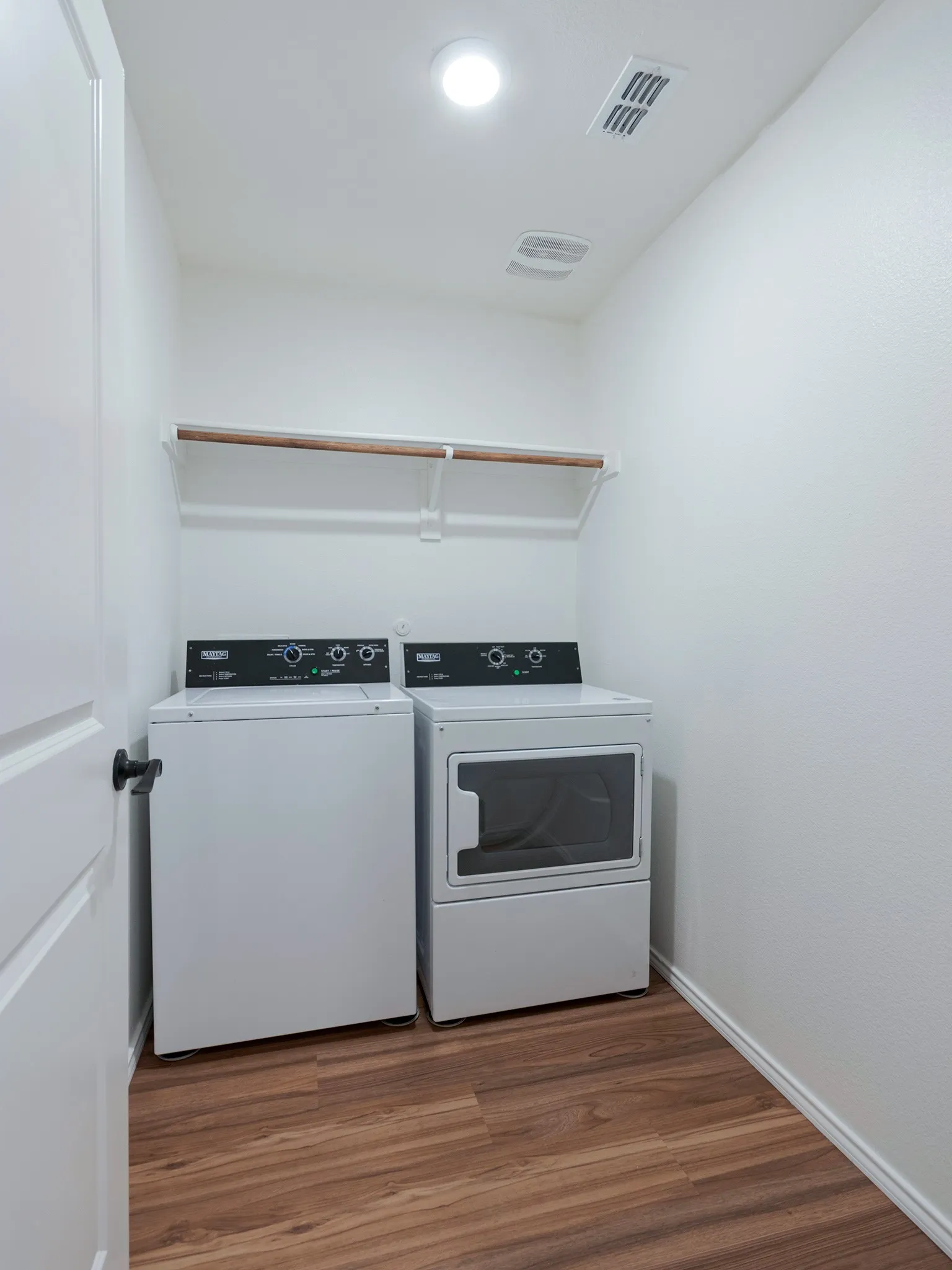 Walk-in laundry room with shelving.
