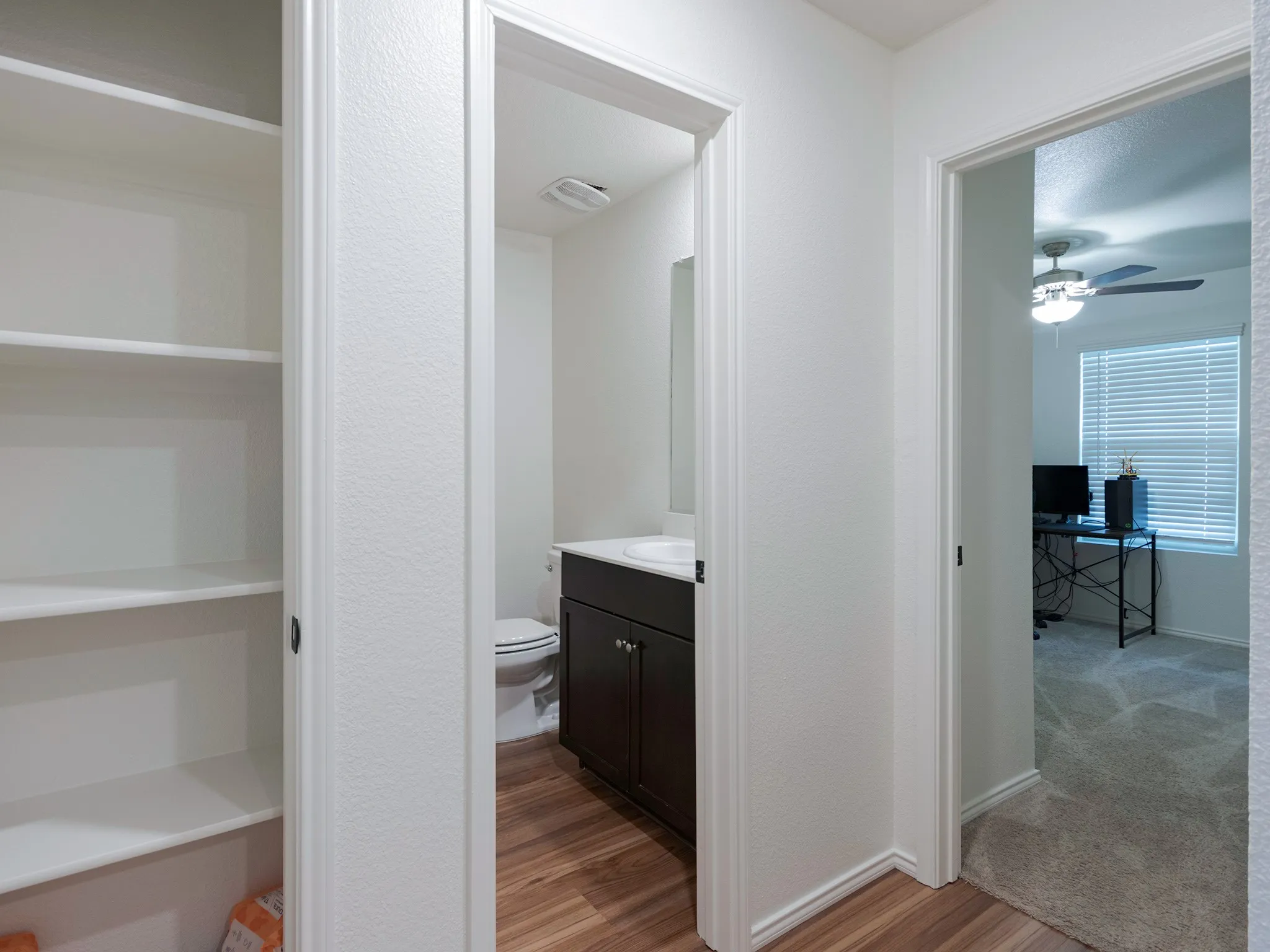 Hall closet storage, secondary bath and secondary bedroom, which is located at the front of the home.