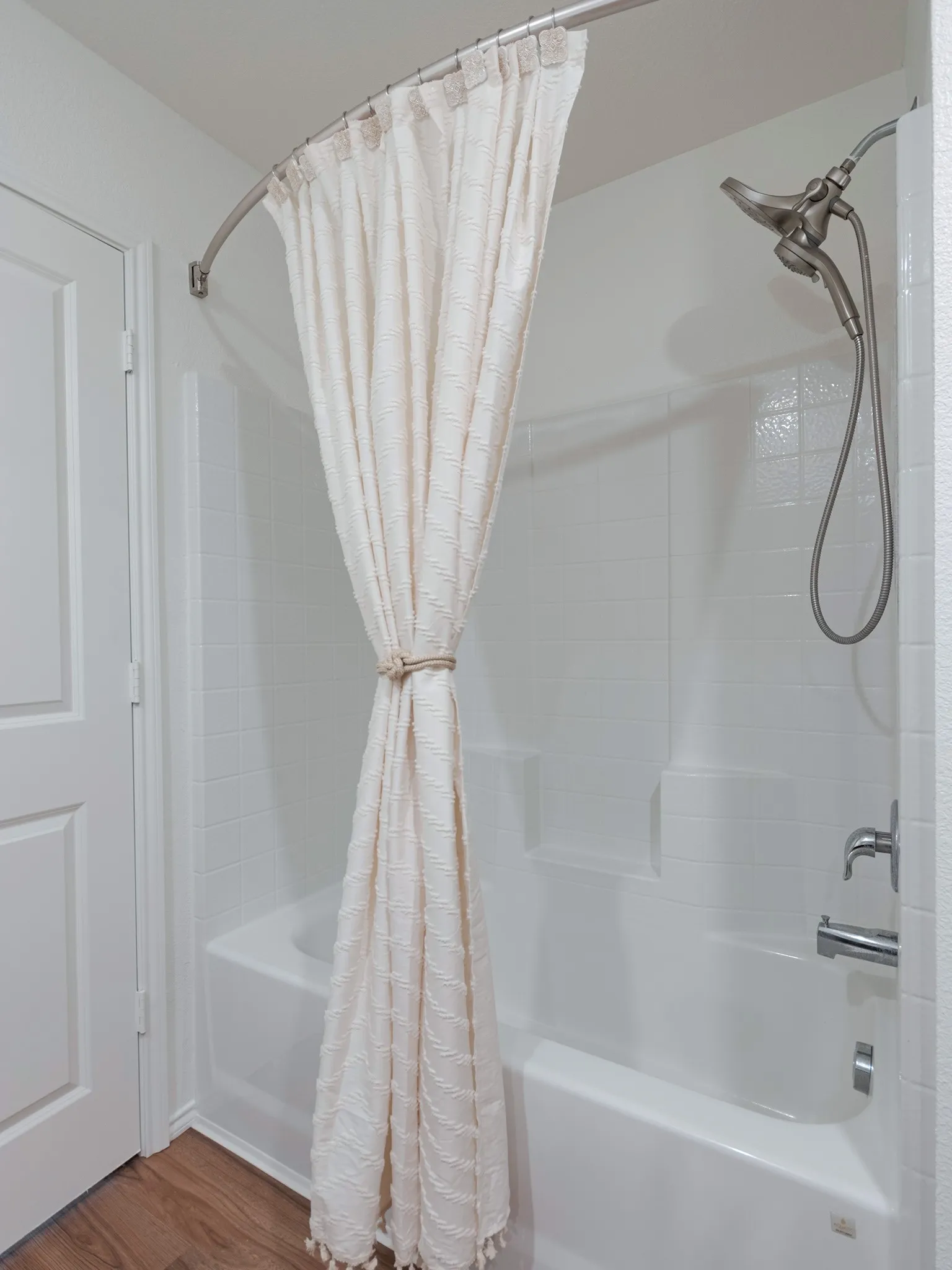 Bath tub with hand-held sprayer.