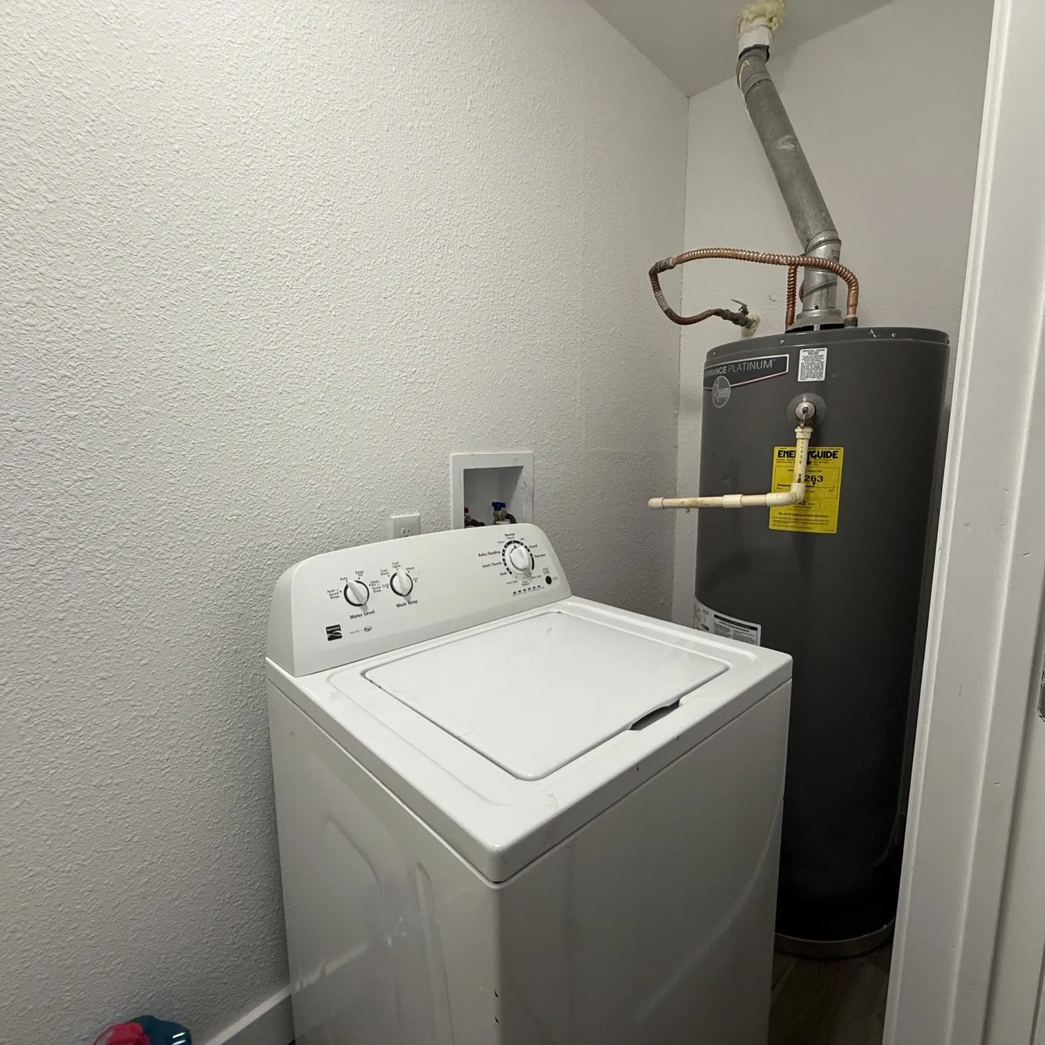 Dedicated laundry area featuring a water heater and appliance hookups