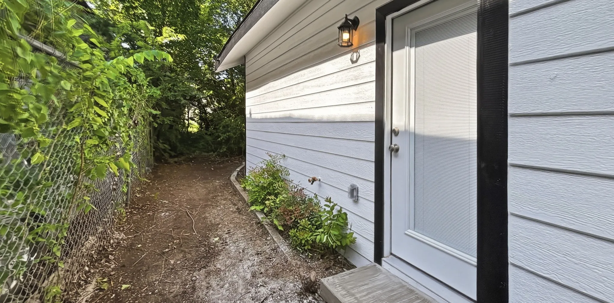 White paneled door with black trim and brushed nickel hardware