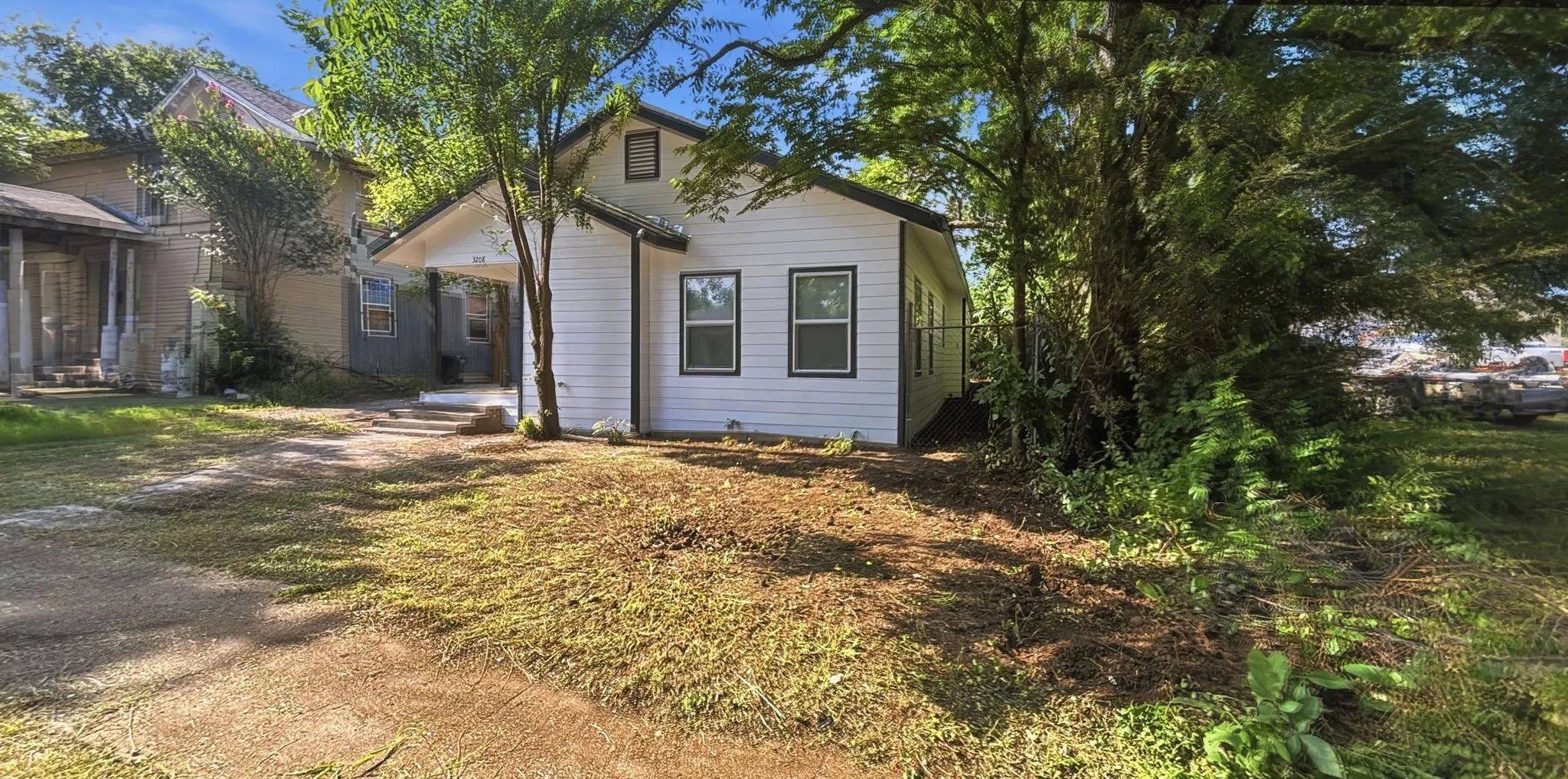 White siding exterior with dark trim windows