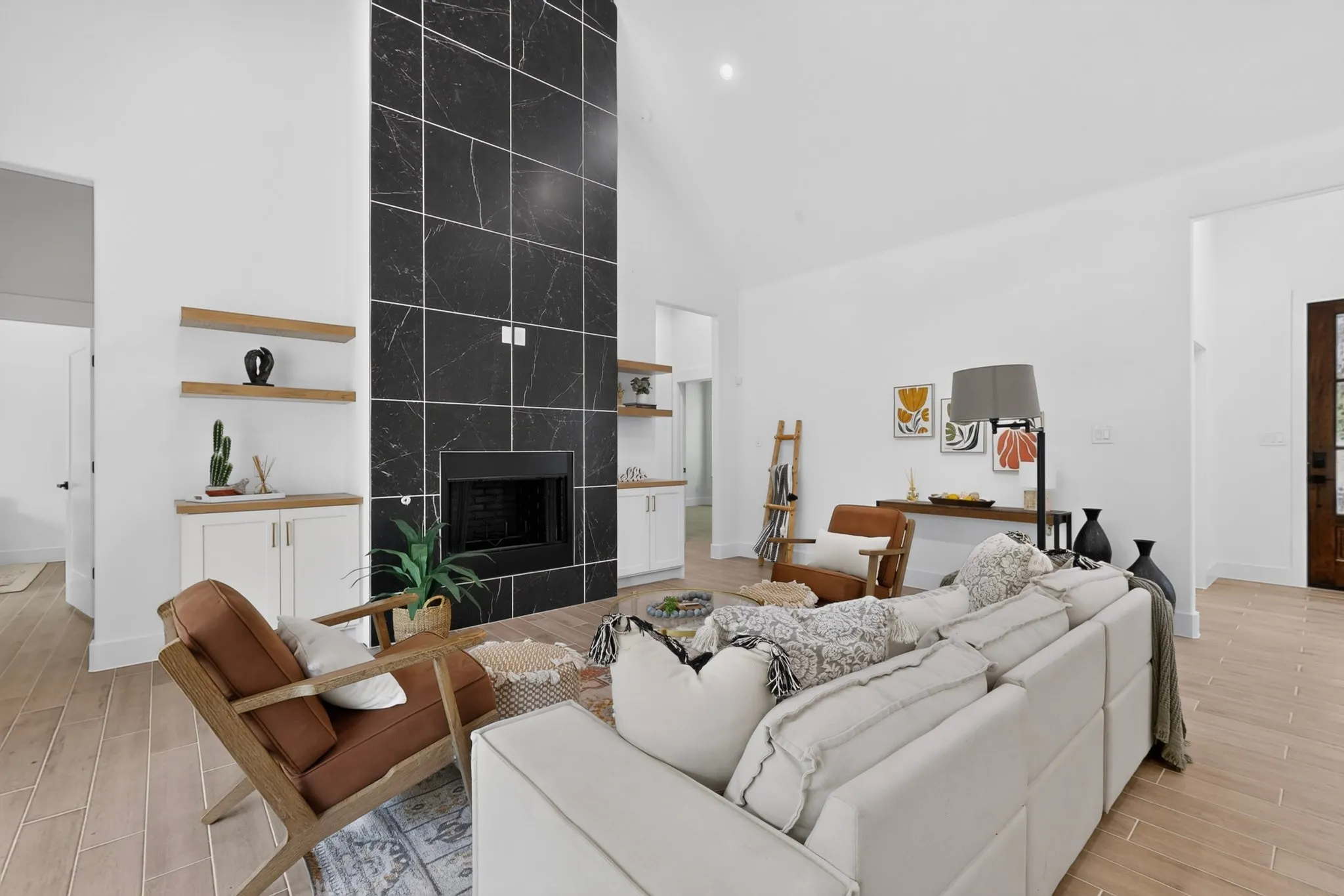 Spacious living area featuring a vaulted ceiling and wood-finish flooring