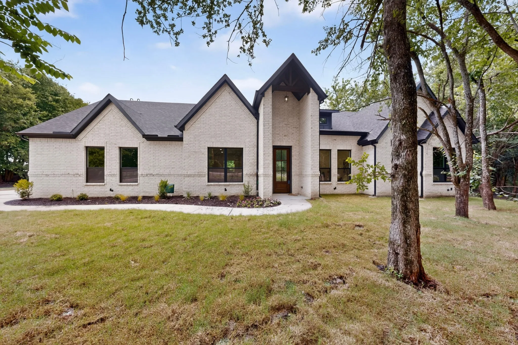 Light brick exterior with dark trim and roof