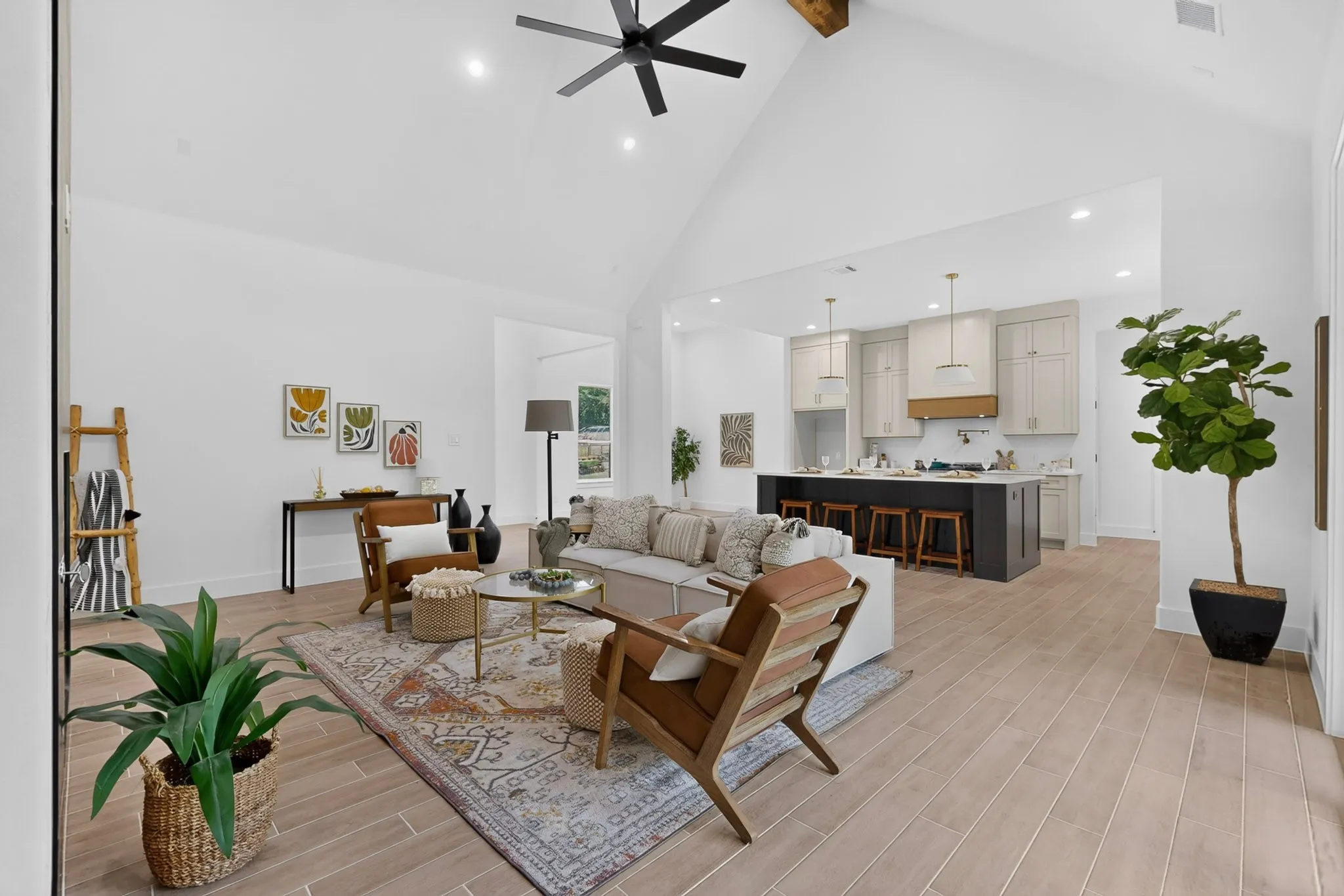 Vaulted ceilings with exposed wood beams highlight the open-concept living space