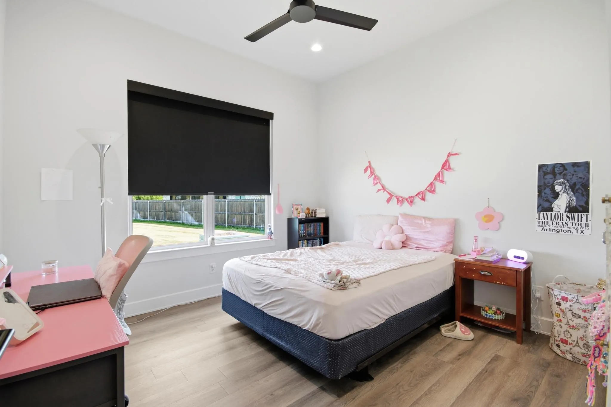 Room featuring wood-finish flooring, a contemporary ceiling fan, and a recessed light fixture