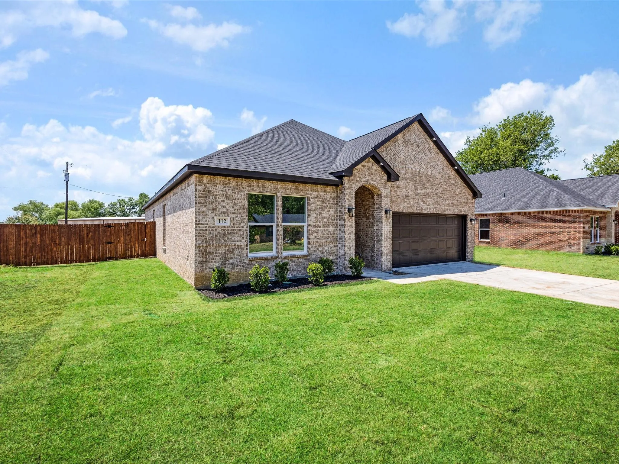 Brick exterior with dark roof and trim details
