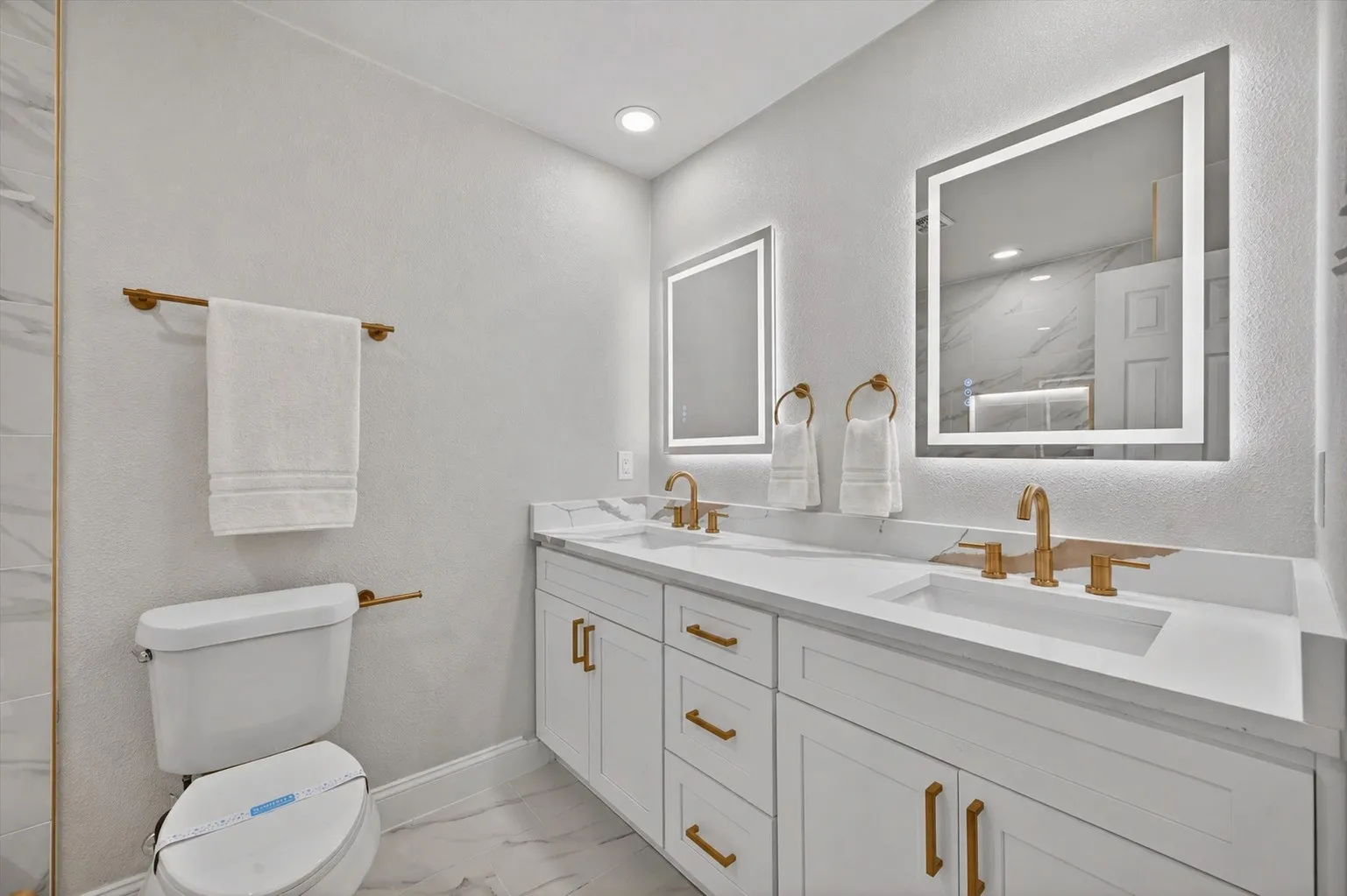 Dual vanity with white cabinetry and integrated sinks