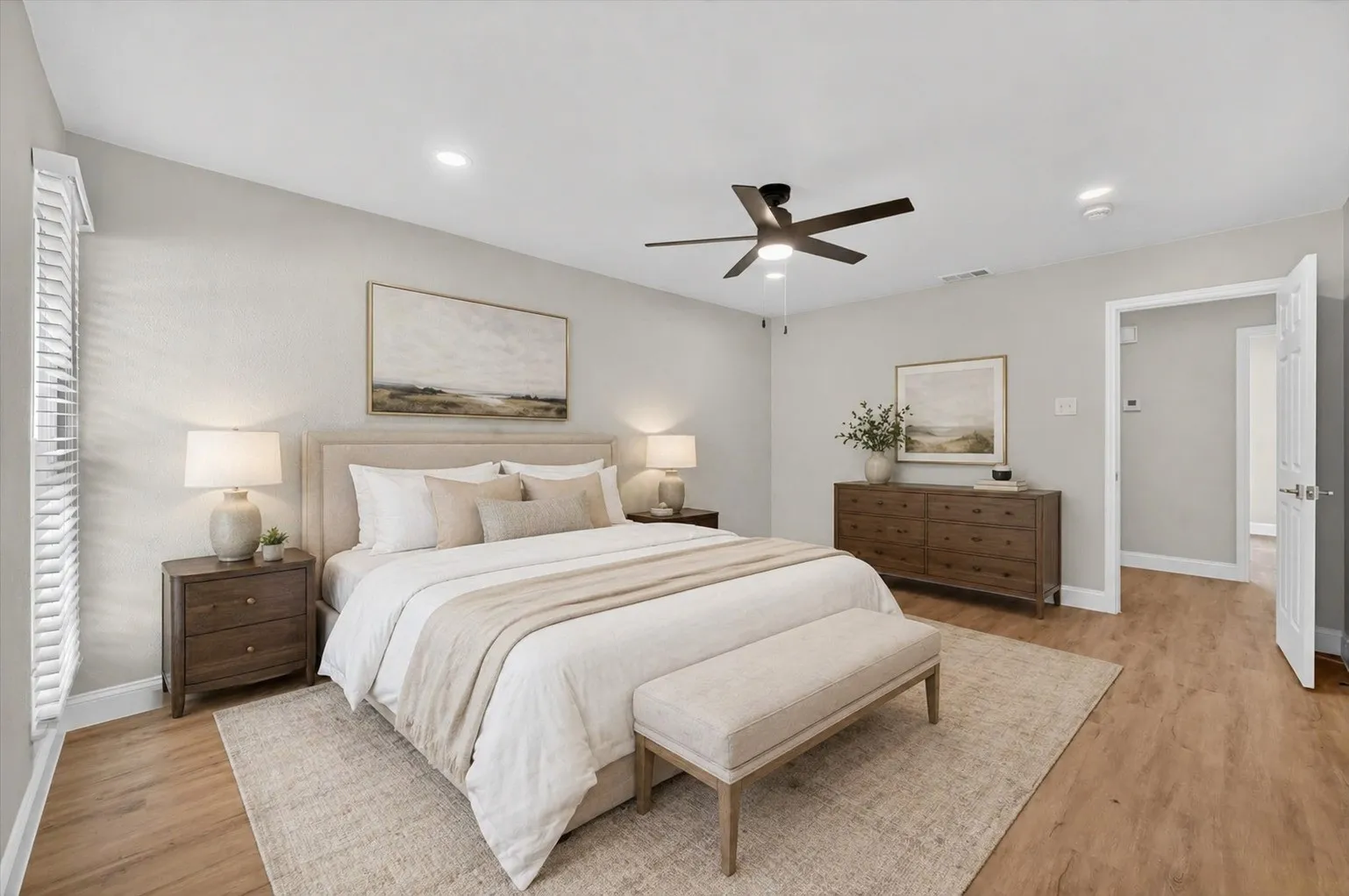 Spacious bedroom featuring wood-finish flooring, recessed lighting, and a contemporary ceiling fan Pics AI Generated