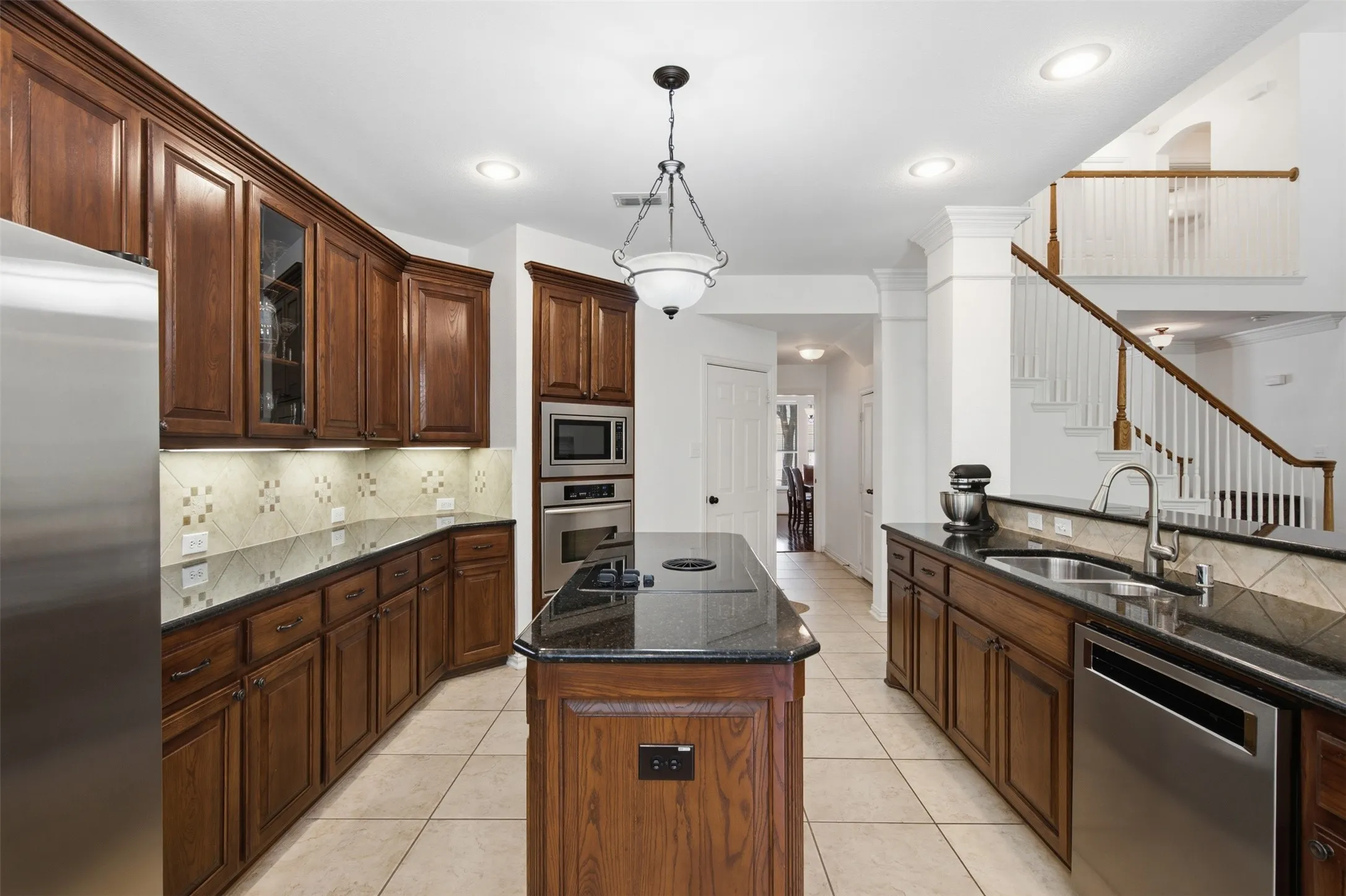 Breakfast nook featuring tile flooring, a glass-paneled exterior door, and a multi-light ceiling fan