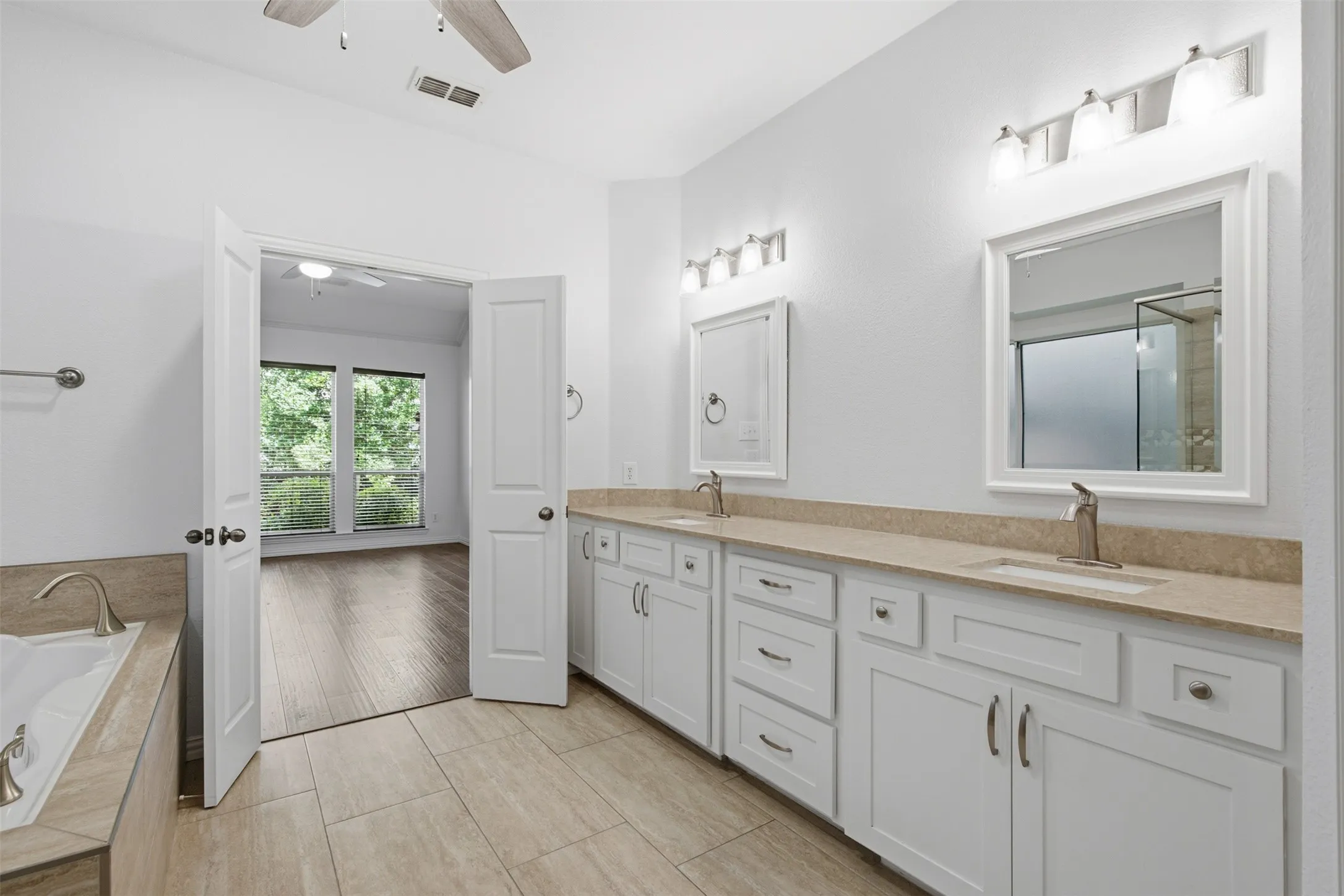 Contemporary bathroom featuring a spacious walk-in shower with glass enclosure and mosaic tile accents, a built-in jetted bathtub, and tile flooring