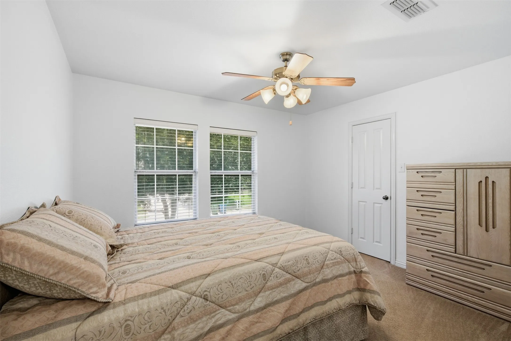 Spacious room featuring neutral carpeting and white walls