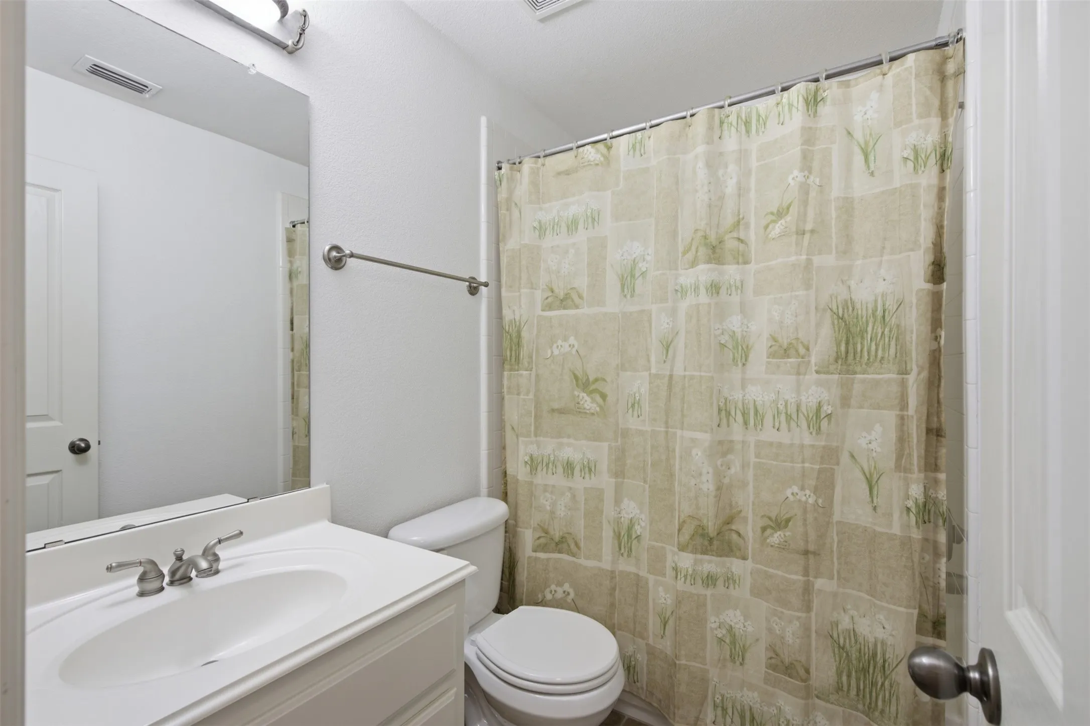 Bathroom featuring a double vanity with integrated sinks and chrome fixtures