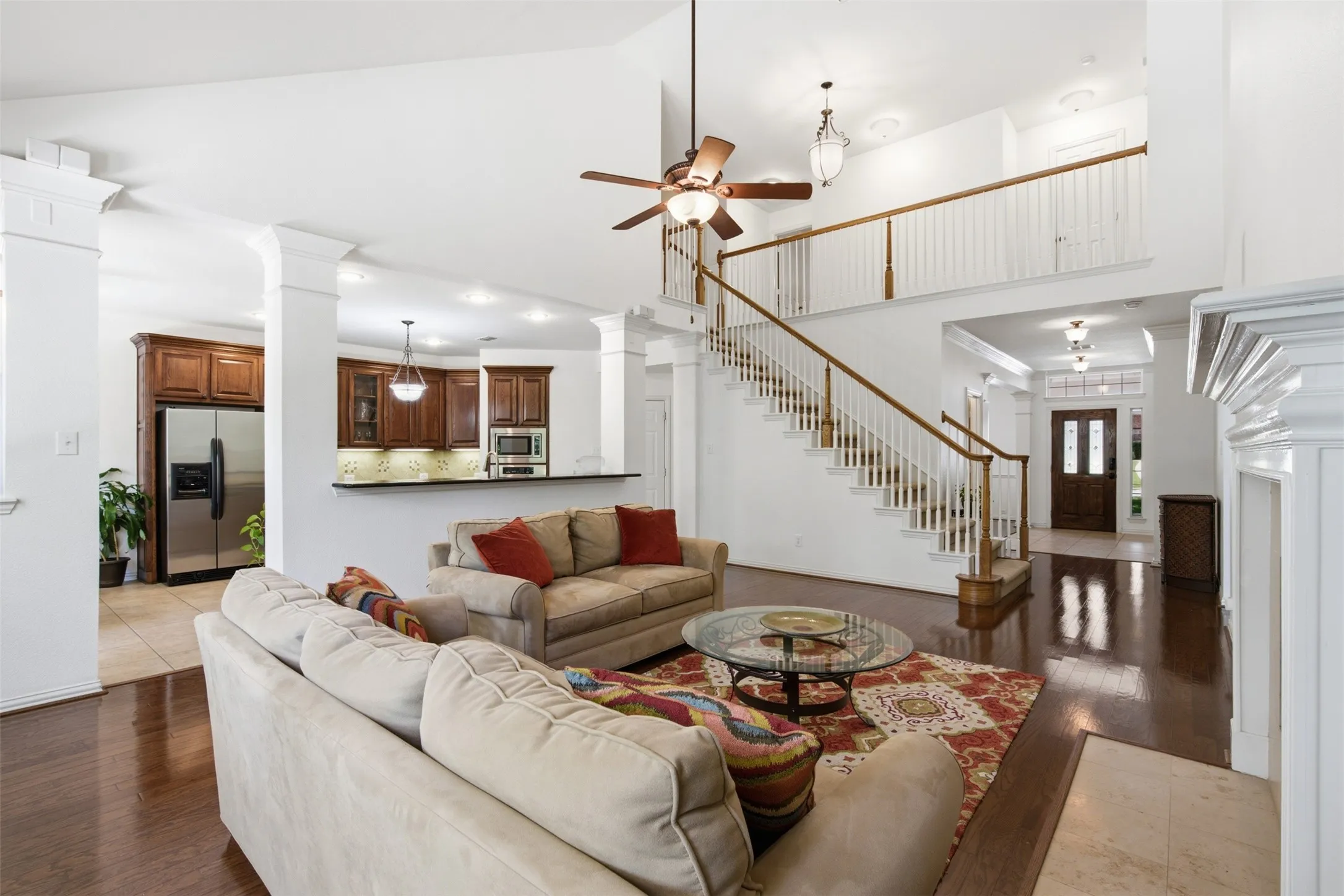 Kitchen featuring wood cabinetry, stainless steel appliances, a central island, dark countertops, and tile flooring