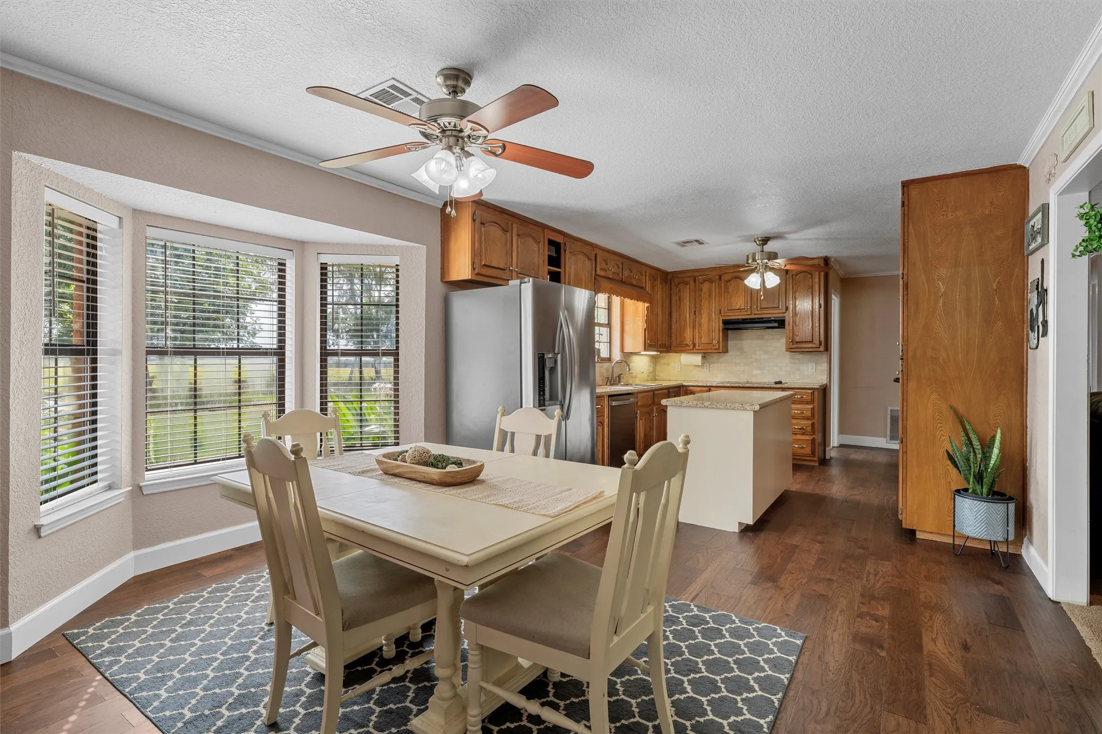 Open-concept kitchen and dining area with wood-finish flooring