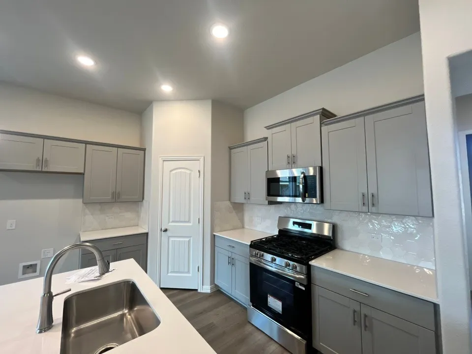 Kitchen featuring stainless steel appliances, light gray cabinetry, white countertops, and recessed lighting